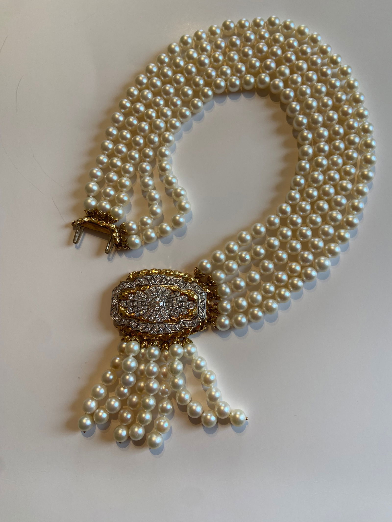 David Webb Cultured Pearl and Diamond Necklace: David Webb cultured pearl, diamond, platinum and 18K gold fringe necklace, designed as a four strand necklace centered by diamond plaque suspending a fringe of cultured pearls, containing 1 old Europe