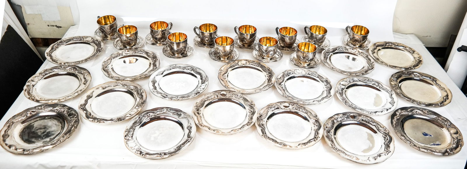 Wing On Co. Silver .850 Quality Dessert Set, 41: Wing On Company rare .850 quality of silver dessert service with dragon motif, comprising 16 plates [8.25" Diameter], and 12 teacups with vermeil interior with saucers, marks to reverse, plates with C