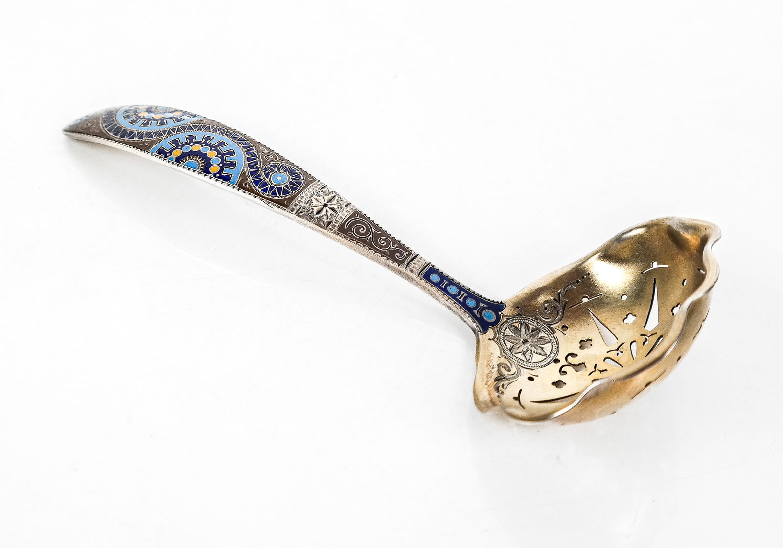 Sterling Silver and Enamel Berry Spoon: Sterling silver, enamel and engraved berry spoon, probably late 19th century, and in the Turkish taste, the enameled handle decorated in shades of blue, orange and taupe, continuing to an elaborately