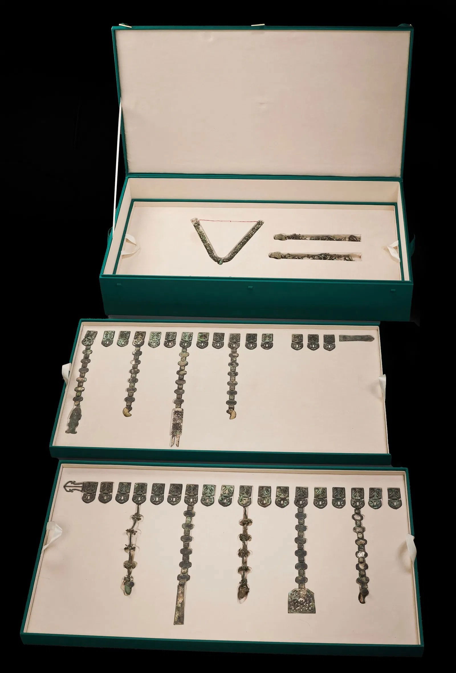 Korean Silla Period Silver Jewelry Collection: Silver jewelry collection, Korea, Three Kingdoms Period (Silla), 5th century CE, silver and curved jade "tiger?s teeth," comprising a silver belt with ten dangling pendants, a pair of earrings with