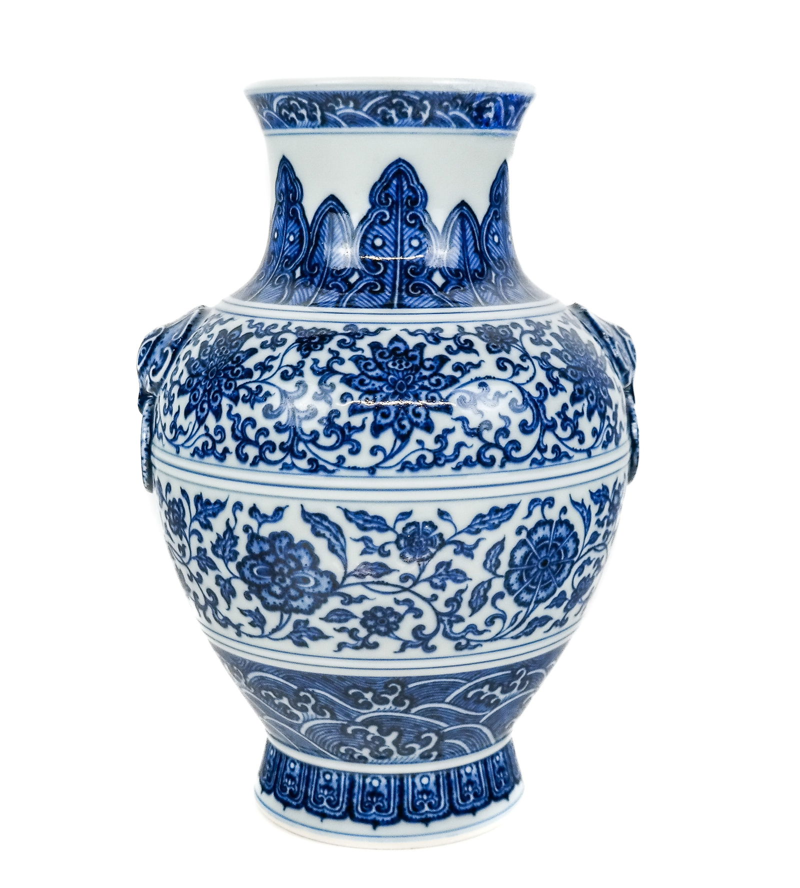 Qianlong Qinghua Blue and White Porcelain Vase: Chinese Qianlong Qinghua decorated blue and white vase, 18th century, with hand decorated wave and floral friezes separated by ridges and with two taotie handles, with Qianlong marks to base. [10" H
