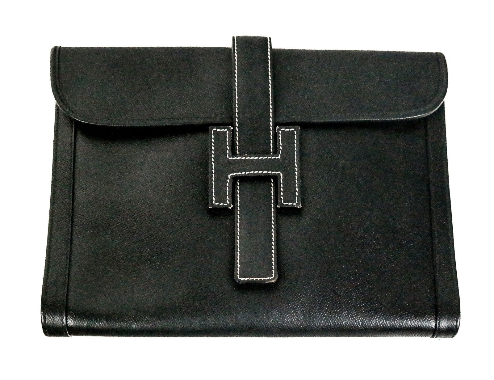 Hermes Jige Black Leather Clutch: Vintage Hermes Jige clutch in grained black leather, "H" enclosure with white stitching, having a single zipper pocket to interior, stamped "Hermes Paris Made in France," with tan dust bag. [9" H x