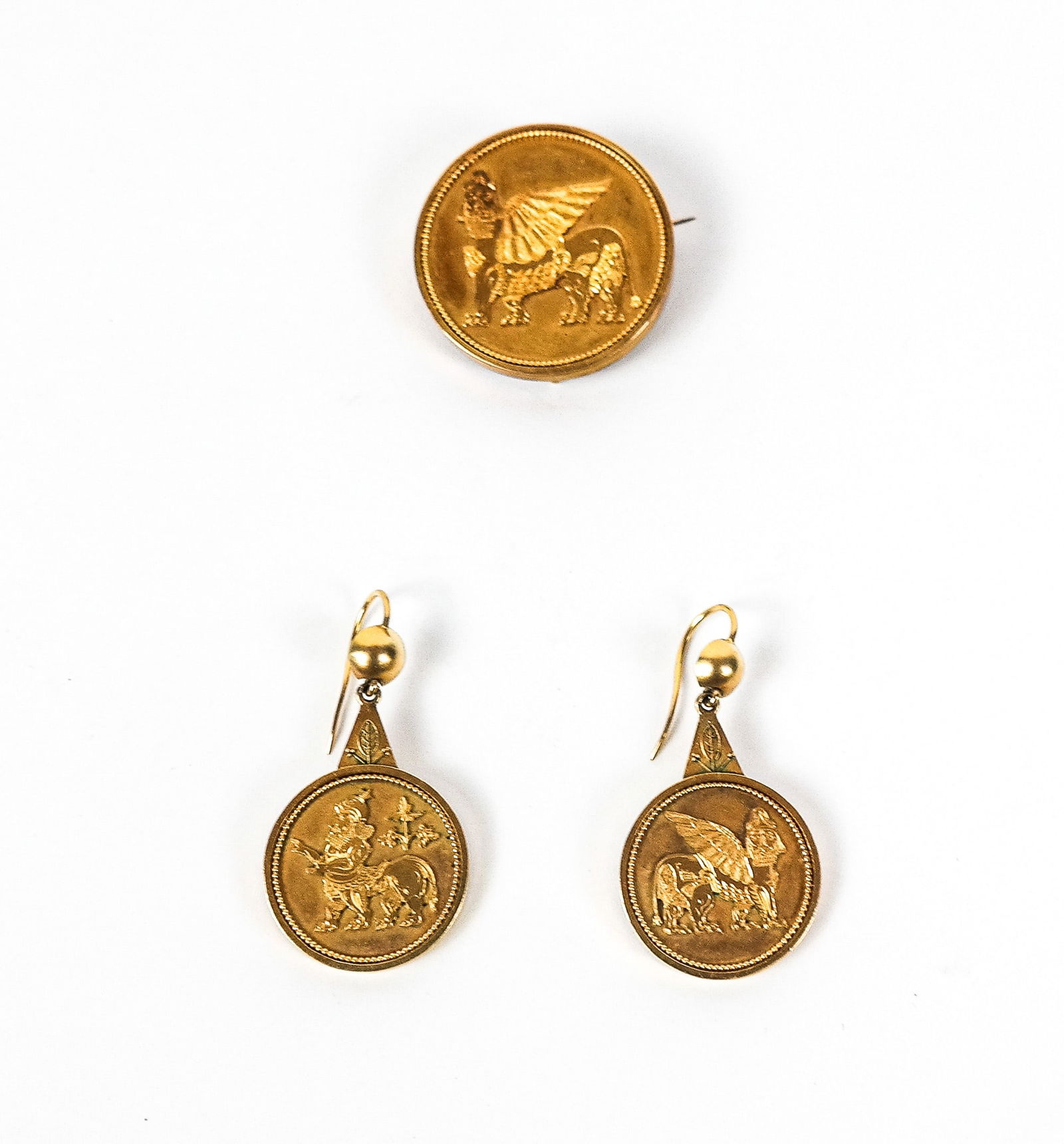 Antique Mesopotamia Revival Gold Locket & Earrings: Antique Mesopotamia Revival gold locket pin pendant and earring set, each of circular design centered by a Lamassu, American, unmarked, tests for 14K gold Total 15.98 dwt. including glass locket