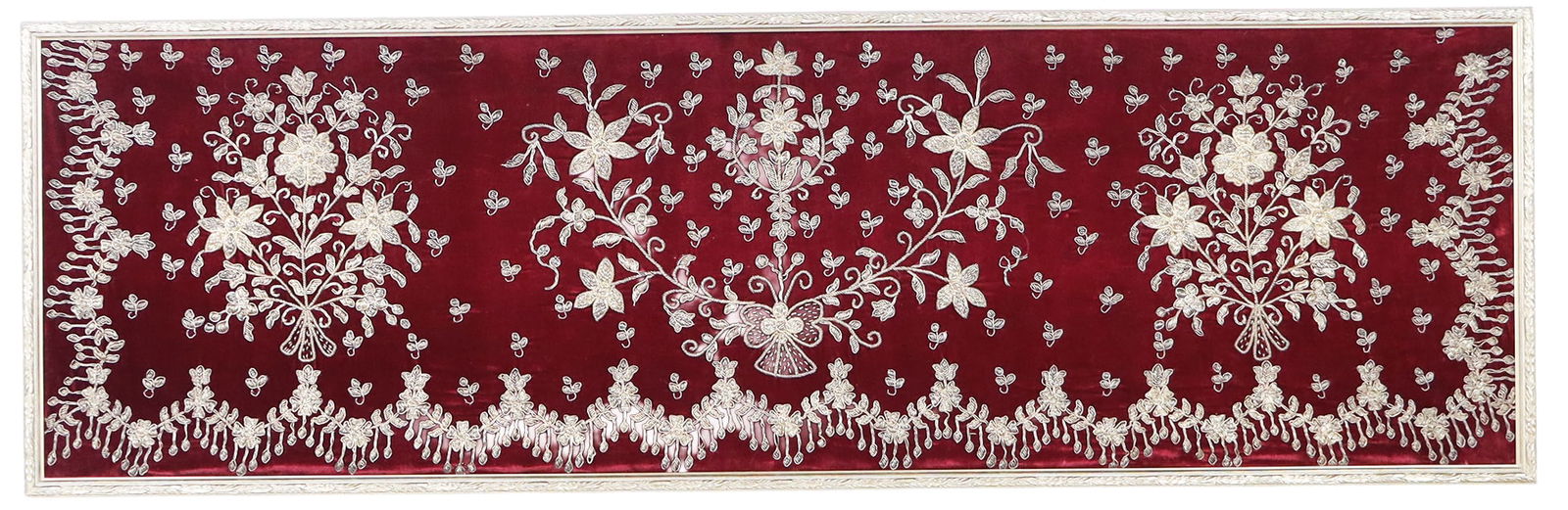 Persian Silver Thread Framed Fabric Panel: Persian silver thread framed fabric panel, the silver thread in puffed embossment of flowers and ribbons with scrolls and tassel designs, on a red velvet background, framed in an acanthus leaf