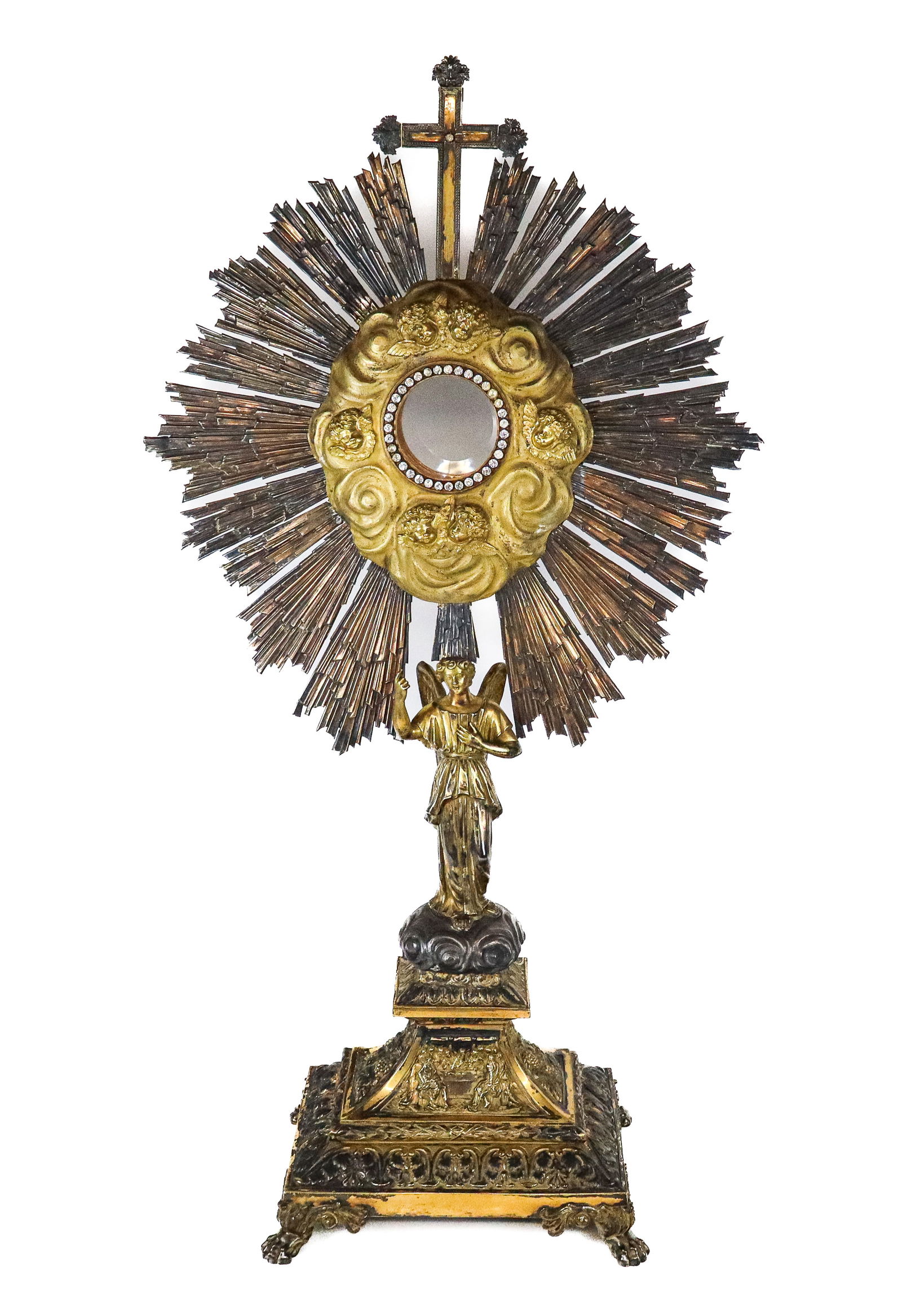 Antique Italian Gilt Silver Monstrance / Reliquary: Antique Italian Gilt Silver Monstrance / Reliquary, the center glass encased surrounded with clear stones, and gilt cherub mounts in cloud form with sunburst flanges and cross pediment; supported by a
