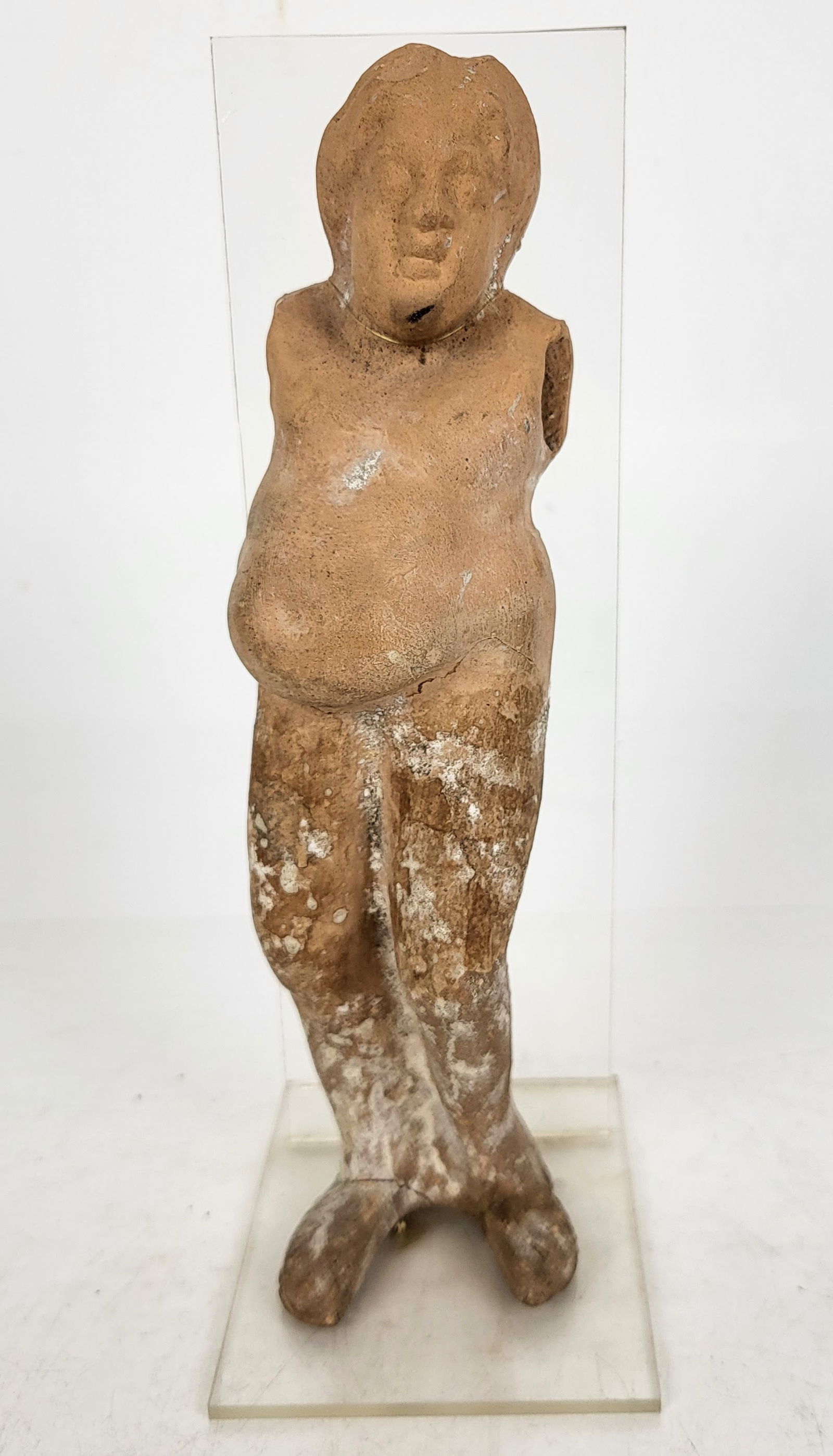 Roman Terra Cotta Woman on stand: Roman Terra Cotta Woman on stand, The figure is missing both arms, in the nude, with torso and head in smooth cleaned finish and below the waist, showing age. [9" H x 3" W x 4" D]. Upper part smooth a