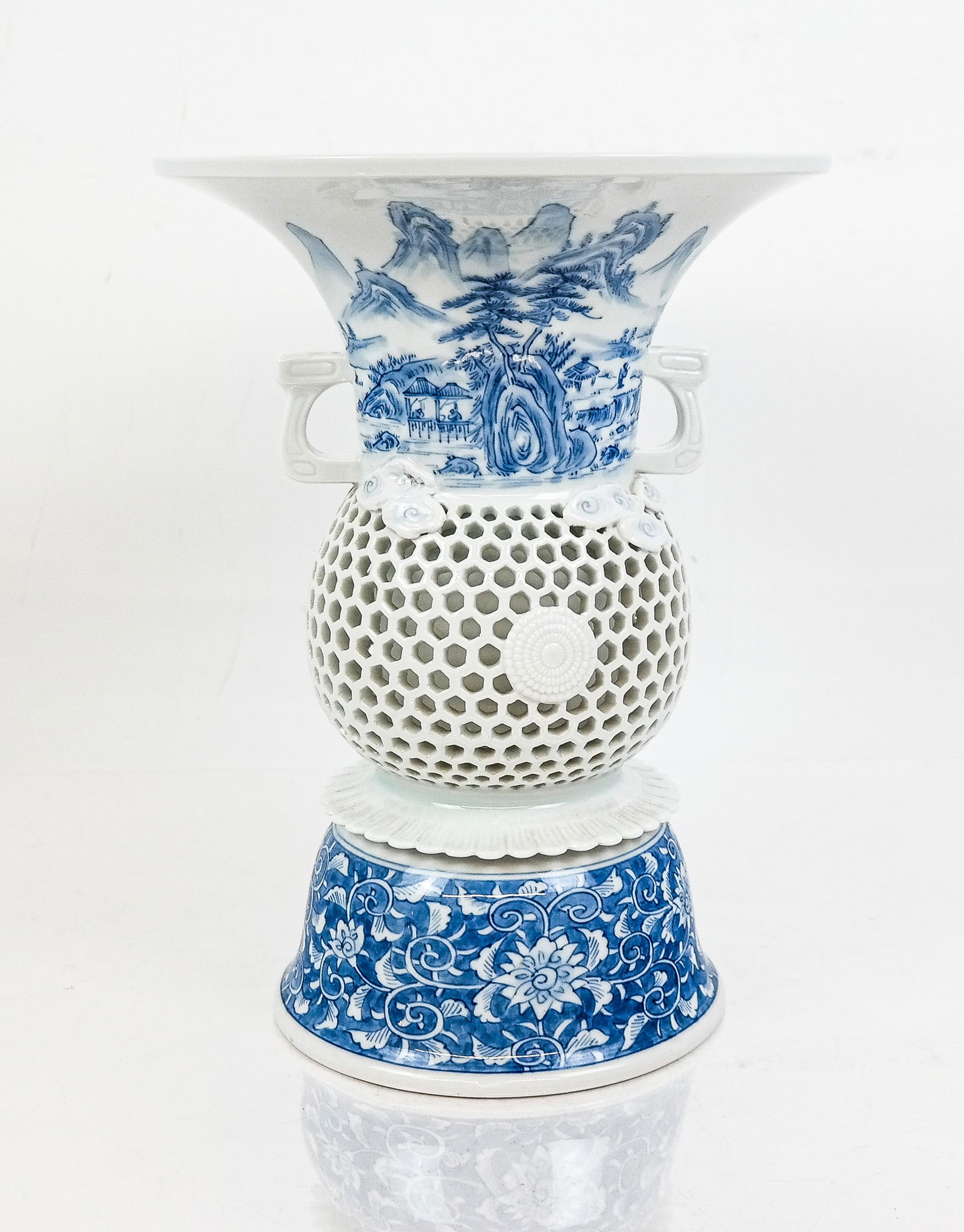 Japanese Antique Hirado Porcelain Reticulated Vase: Japanese Antique Hirado ware porcelain reticulated vase, the wide flared top over a center body in reticulated round shape and mounted clouds, on a flared base with blue and white exterior designs, an