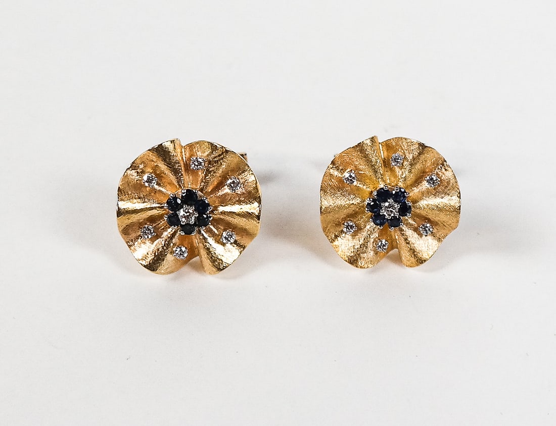 Pair of Gold, Sapphire and Diamond Cufflinks: Pair of 14K and 18K yellow gold, diamond and sapphire flower cufflinks, set with 14 round brilliant-cut diamonds and 12 round sapphires, cufflink backs marked 14K, flowers unmarked but test for 18K go