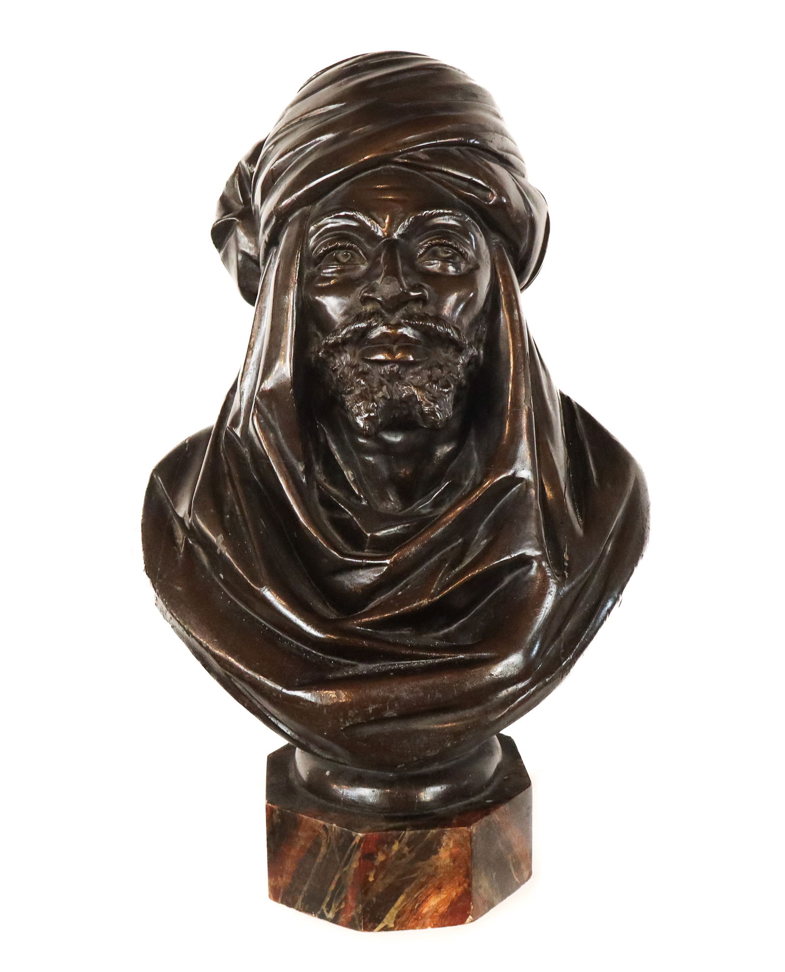 Carved Wood Bust of an Arabian Man: Carved wood bust of an Arabian man, the bearded man with full turban into shoulder wrap, as a bust, mounted onto a round plinth base and faux marble stand. No signature. Late 19/early 20 century. [25"