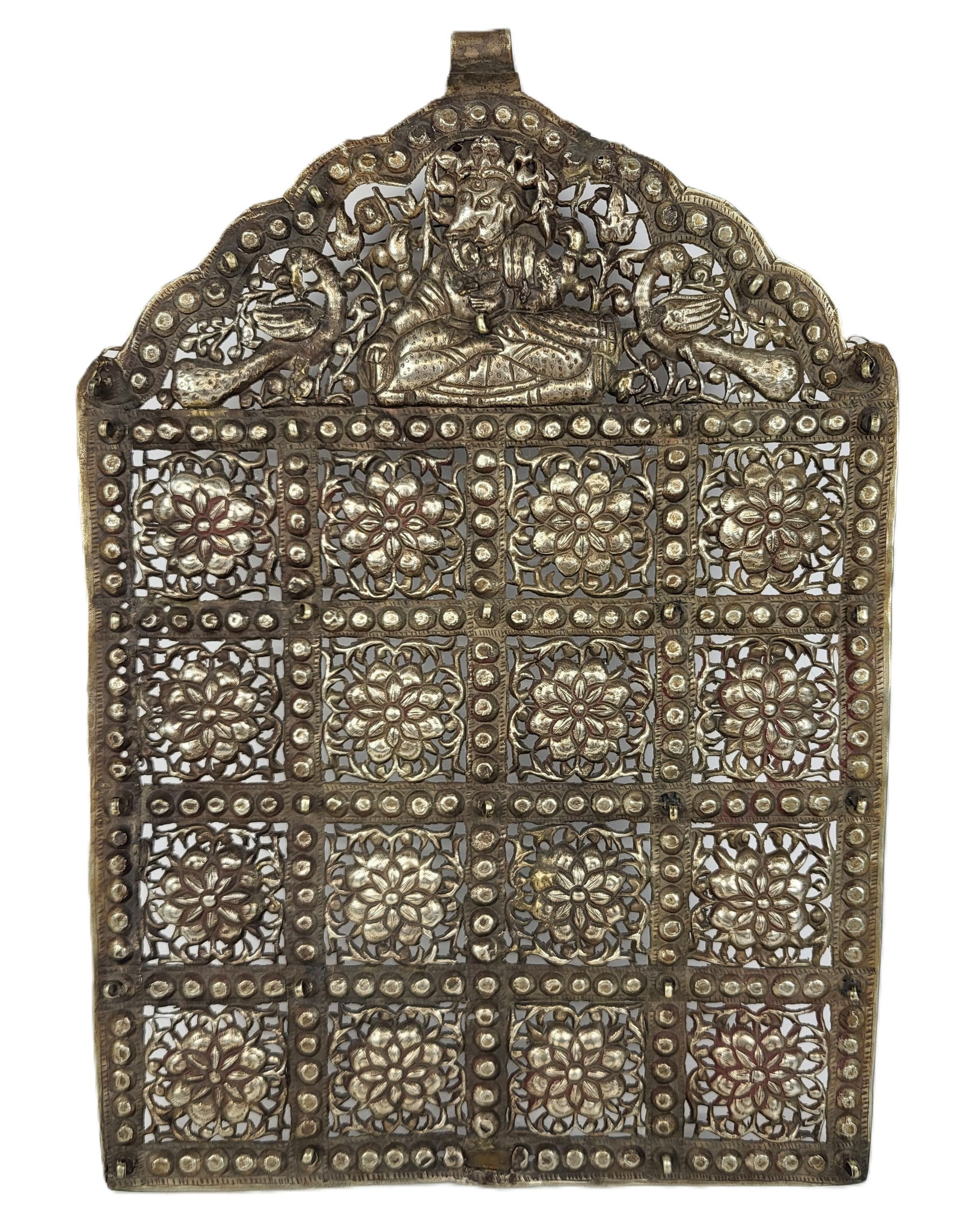 Indian Silver Repousse and Pierced Plaque: Indian silver repousse and pierced plaque, the angled pediment depicting Ganesha with flowers and birds, above a repeating pattern of rosettes in squares. [10 ozt., 15" H x 10.5" W]. Good condition, v