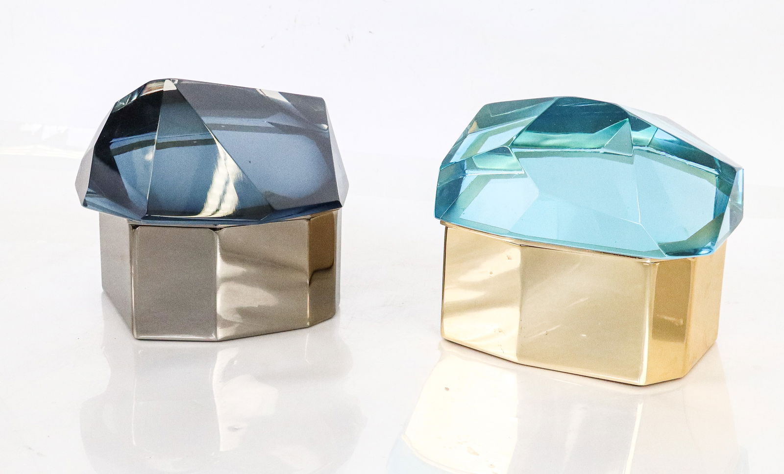 Pair of Ultra Modern Glass Covered Chromed Boxes: Pair of glass covered chrome decorative boxes, Italian, 20th century, in shades of blue. Nine (9) sided boxes with conforming glass covers mimicking cut jewelry stones, one box chrome, the other box g