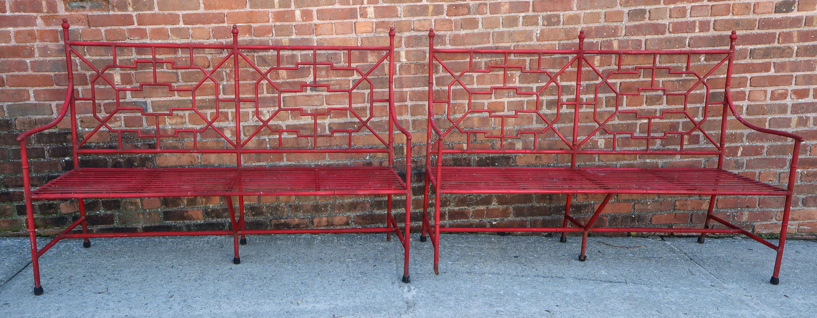 Pair of Chinese Chippendale Red Painted Benches: Pair of Chinese Chippendale style red painted metal garden benches. [42.5" H x 57.5" W x 21" D, 17" Height to seat]. Overall condition is fair, with losses to paint, 2 feet broken].