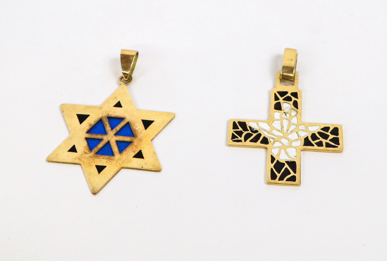 Two Plique-a-Jour Enamel and Gold Pendants: Two plique-a-jour enamel and 18K gold pendants, comprising a cross and a six pointed star, cross gold marked rubbed and numbered 14278, star unmarked (both test for 18K). [Total 11.5 dwt., Cross