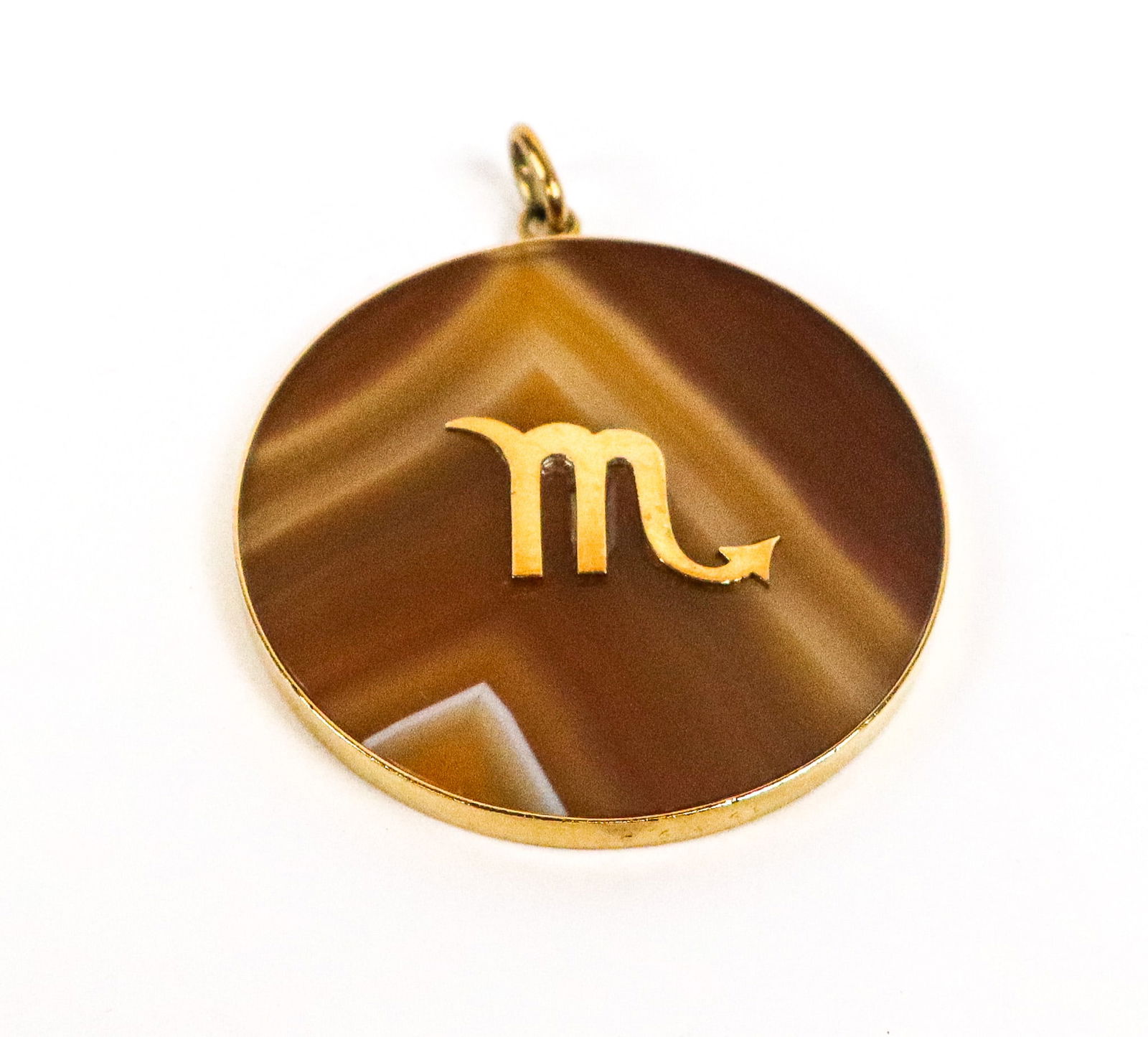 Cartier Gold and Agate Zodiac Pendant: Cartier 18K gold and agate zodiac pendant, signed 18K Cartier. [1.5" Diameter]. Overall condition is good.