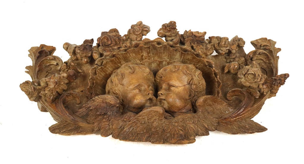Rococo Carved Wood Applique with Putti: Rococo carved wood applique with putti, 18th century, with foliate and fruit carved frame. [18" H x 38" W x 6" D]. Condition is good to fair with losses and repairs.