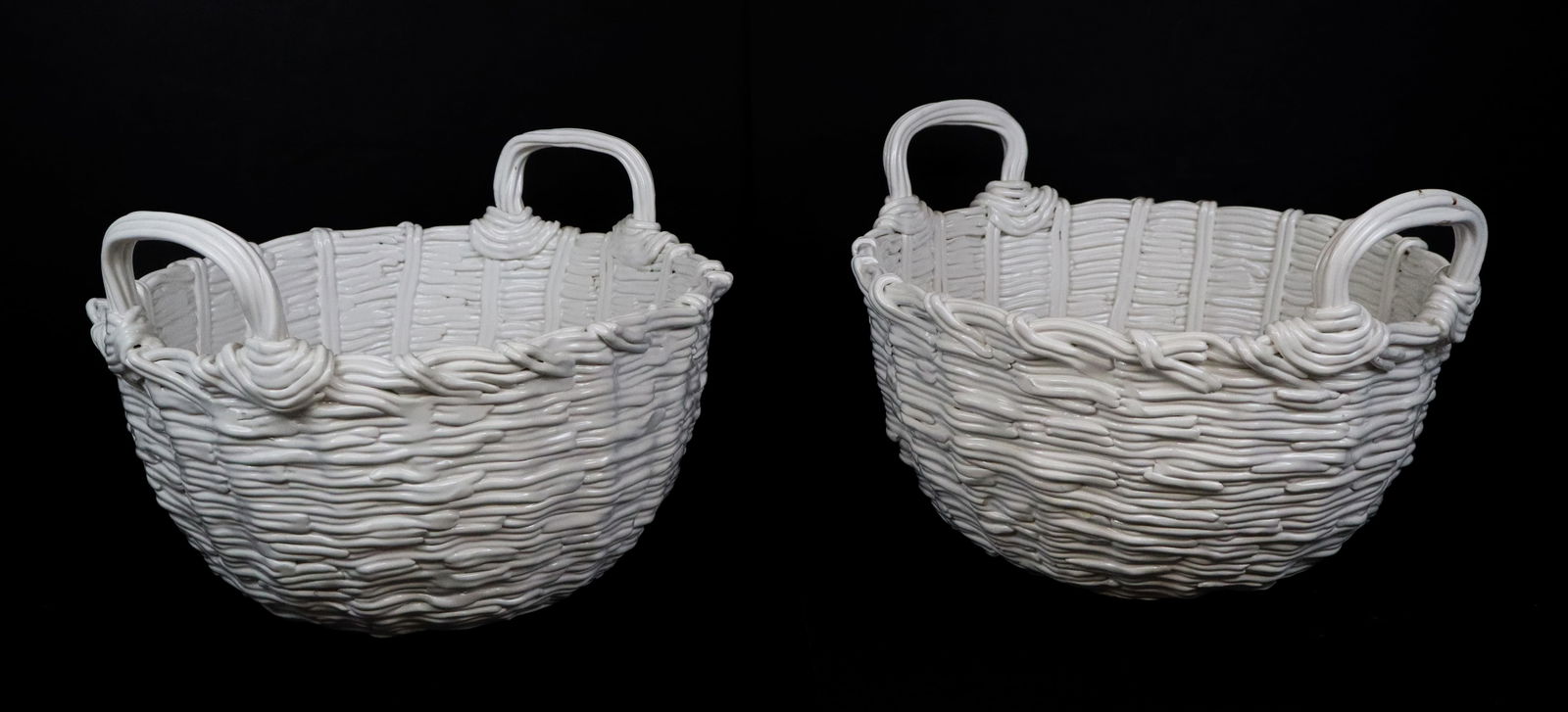 Gumps Pair of White Ceramic Baskets: Gumps pair of white ceramic two handled baskets, Italian, signed on base. [10.5" H x 14.5" W x 13.5" D]. Overall condition is good.