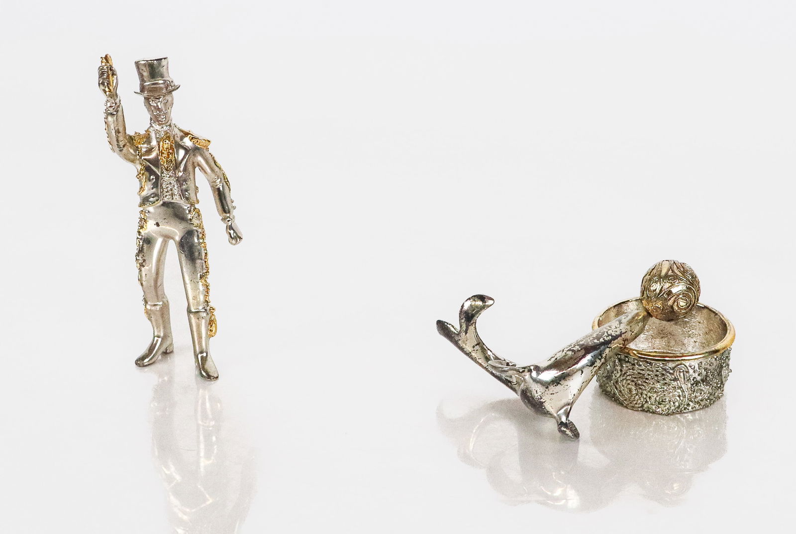 Franklin Mint "The Silver Circus" Sculptures, 2: Two Franklin Mint "The Silver Circus" sculptures in sterling silver with gold wash accents, comprising "The Performing seal" designed by Sasha Brastoff with Certificate of Authenticity [Figure: 3.25"