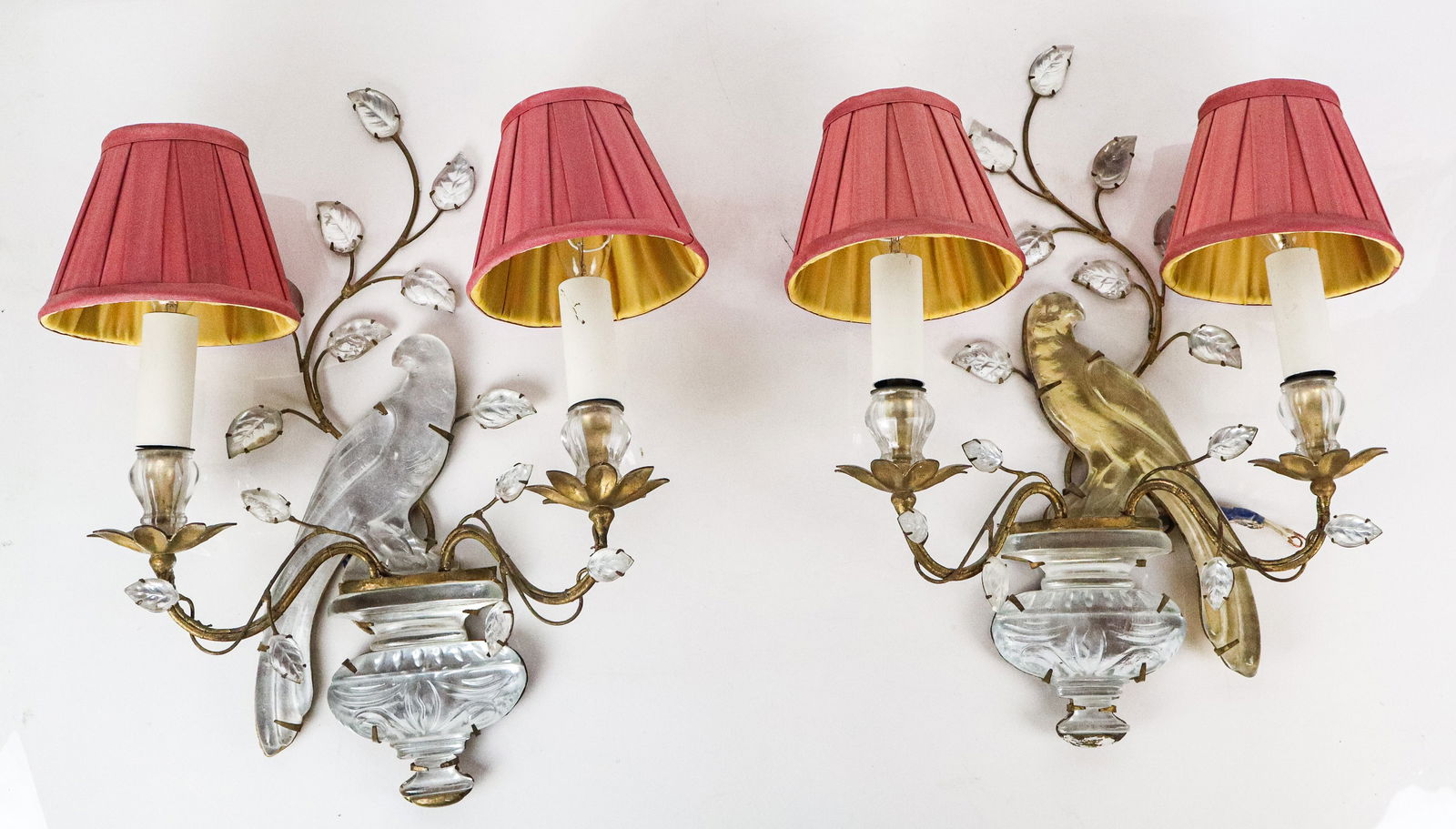 Bagues Inspired Pair of Two Light Bird Sconces: Bagues Inspired pair of two light bird sconces, probably French, each designed as a bird resting on an urn form vase amidst branch with leaves flowerhead bobeche for lights, with silver and gold leaf