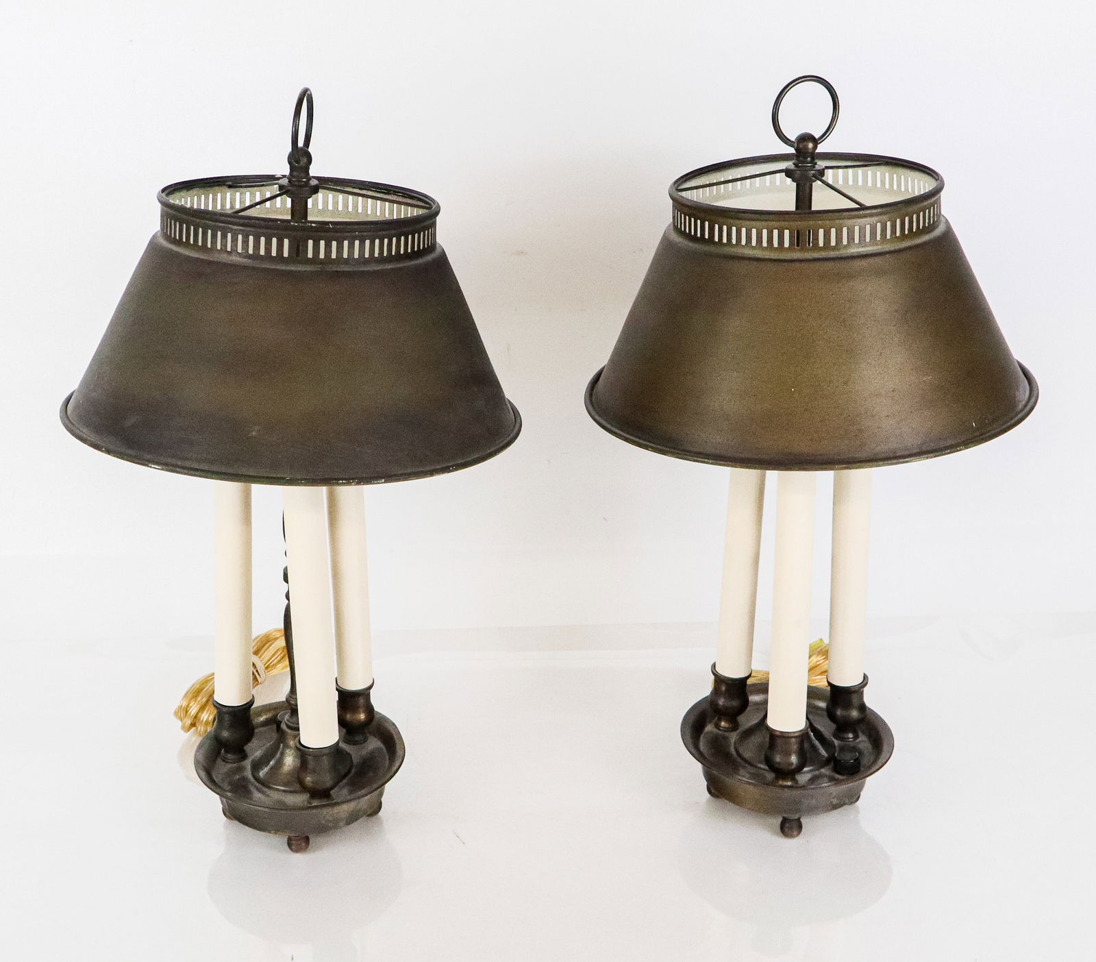 Pair of Bouillotte Lamps: Pair of bouillotte lamps, early 20th century, each with tole shades and footed bases. [18.5" H x 10" Diameter (of shade)].