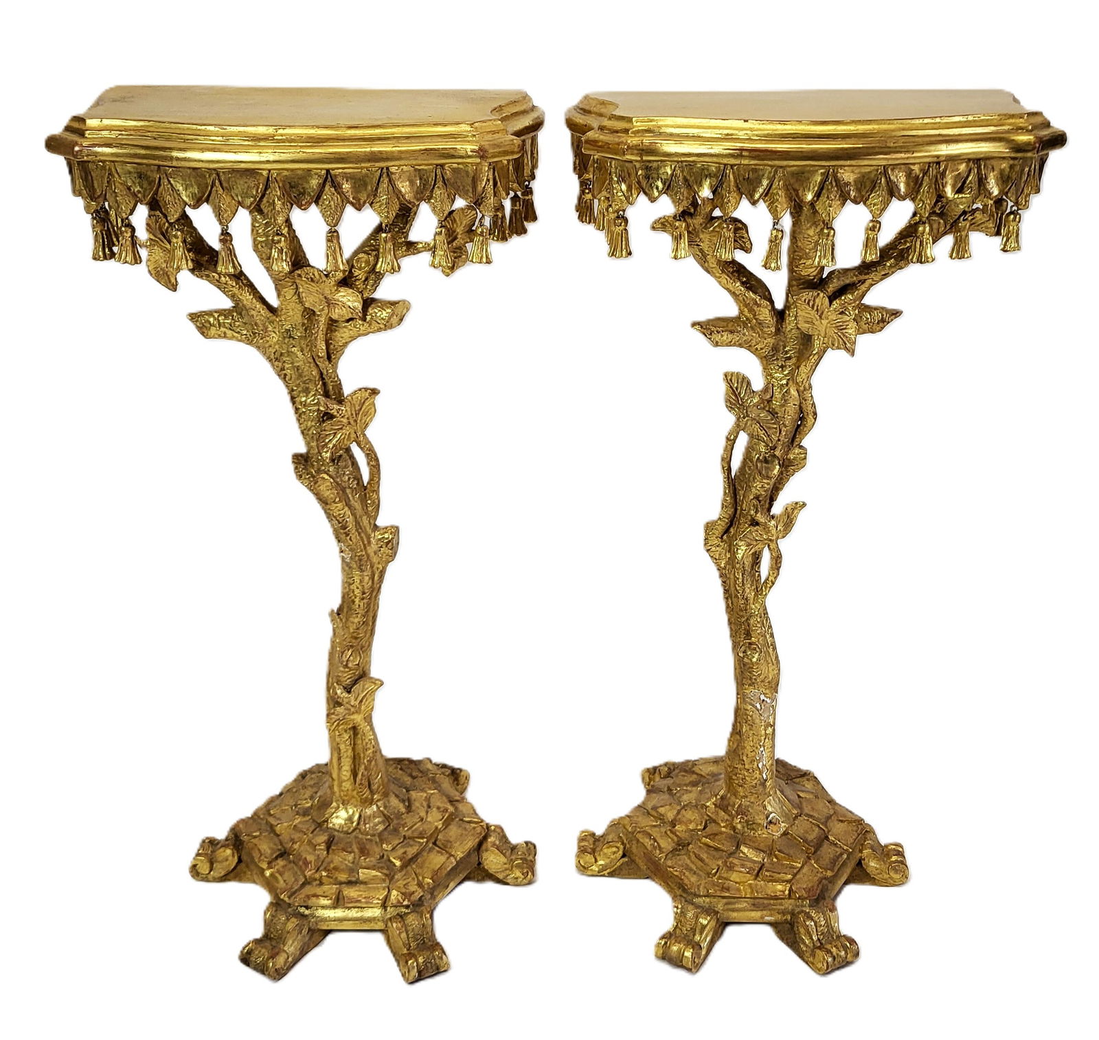 Pair Venetian Gilt Carved Console Stands: Pair Venetian gilt carved console stands, the flat bracket tops with valance skirts and tassels, on trunk like posts, on scale/turtle back bases and 6 feet each. All over gilt and carved. [32" H x