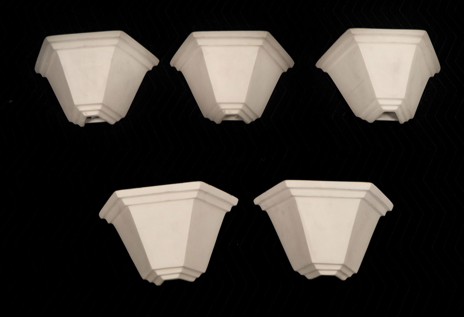 Five Semi-Hexagonal Bisque Porcelain Sconces: Group of bisque porcelain sconces, 20th century, in a semi-hexagonal form, marked "Faddy" to reverse. [8" H x 12.5" W x 5.75" D]. Condition is good with some surface wear.