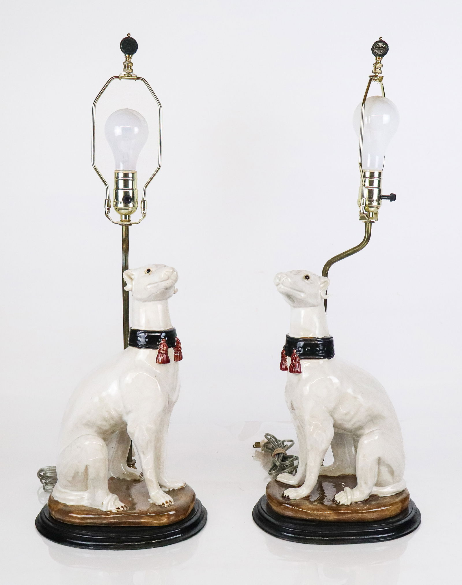 Hollywood Regency Porcelain Whippets as Lamps, Pr: Pair of Hollywood Regency porcelain sculptures of whippets, mid-20th century, in a Chinoiserie style mounted as lamps on wooden bases, apparently unmarked, with wiring being exterior to original figur