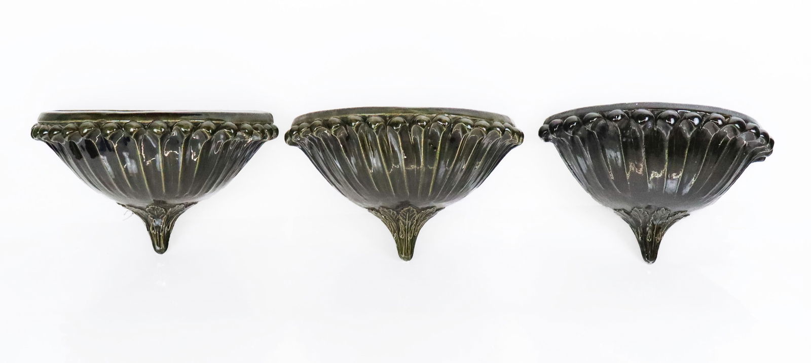 Set of 3 Anthemion Ceramic Light Sconces: Set of three anthemion form hunter green glazed uplight wall sconces, one marked Baga SRL, Italian, 20th/21st century. [8" H x 14" L x 7.5" D]. Overall condition is good, some wear/minor loss to