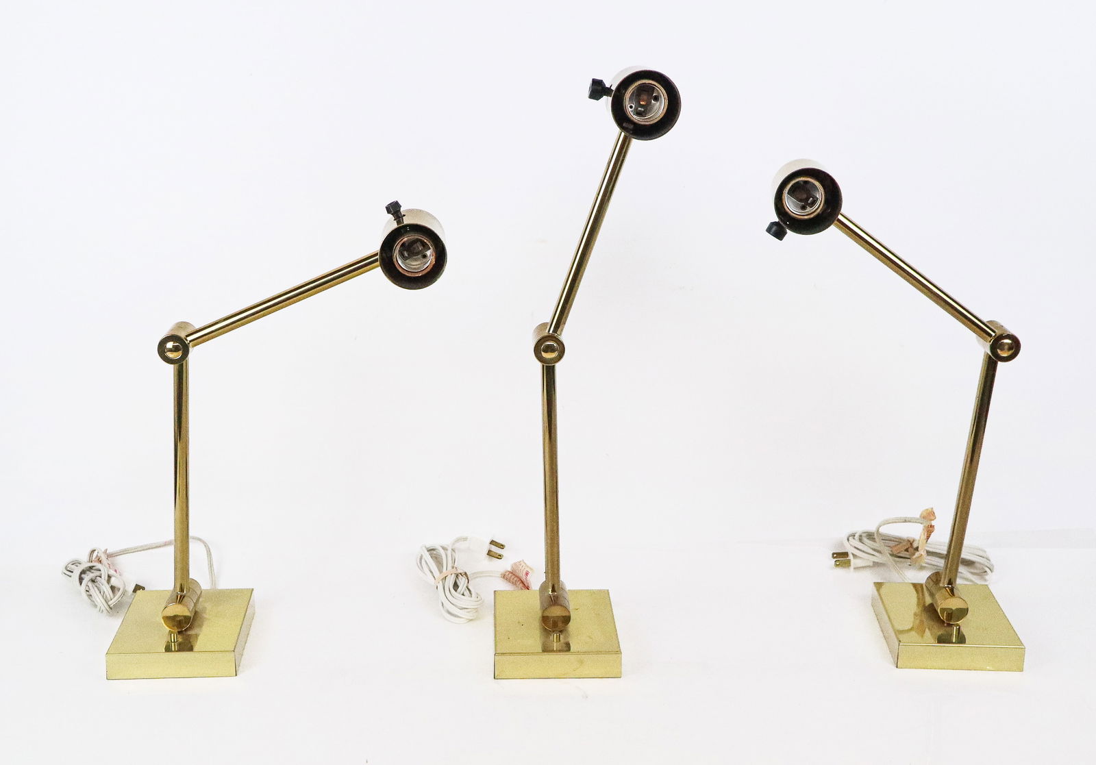 Koch and Lowy Set of Brass Articulating Sconces, 3: Set of 3 mid-century modern brass articulating sconces, 2 with tags, unmarked. No shades. [5" H x 12" W unextended]. Some scratches to brass, one missing one set screw.