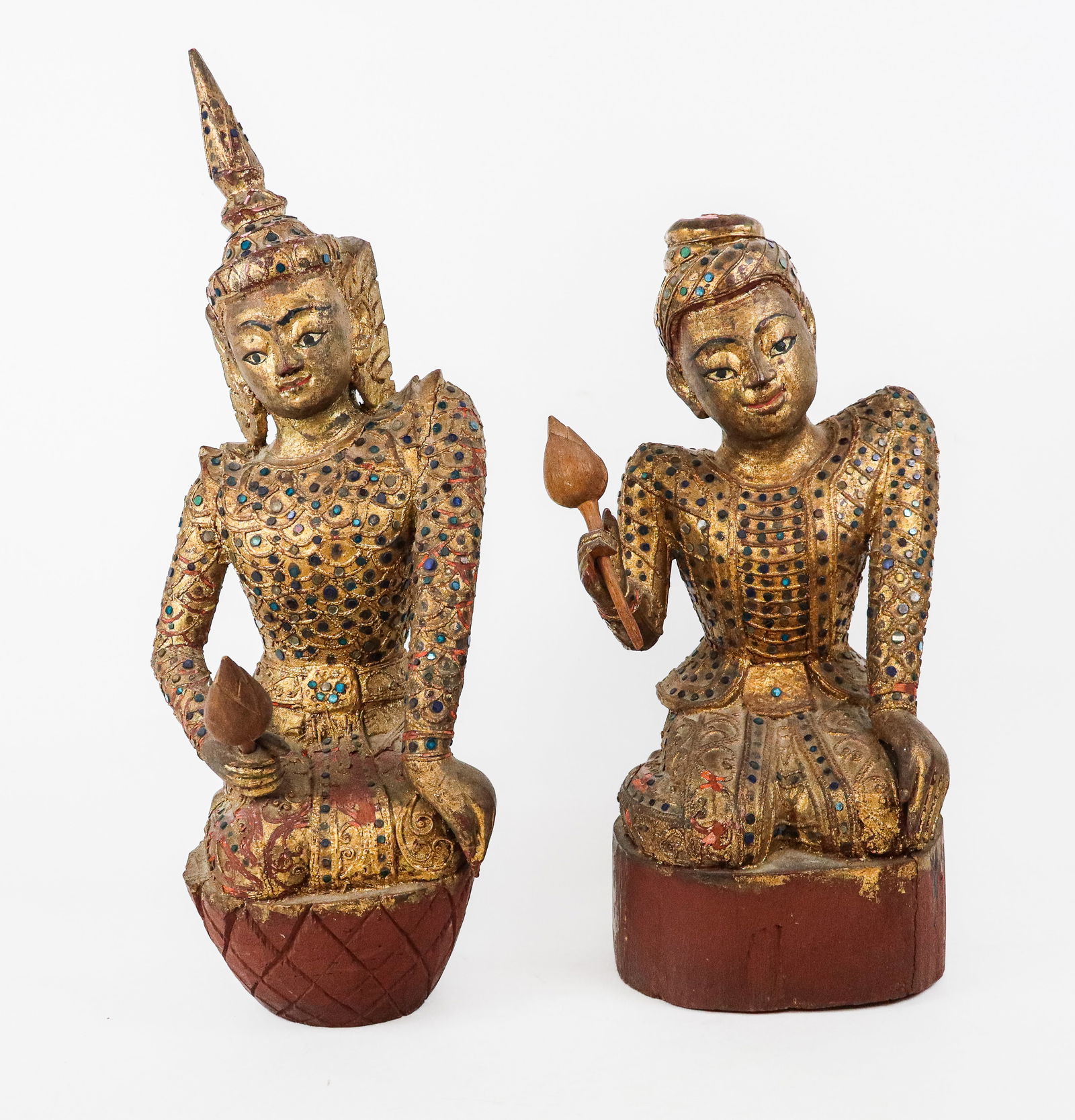 Pair of Thai Gilt Temple Dancers: Pair of gilt carved Thai temple dancers, at rest, all over colored mirror mosaic, each with a flower. [Tallest: 20" H]. Many chips and losses, one hat finial missing.