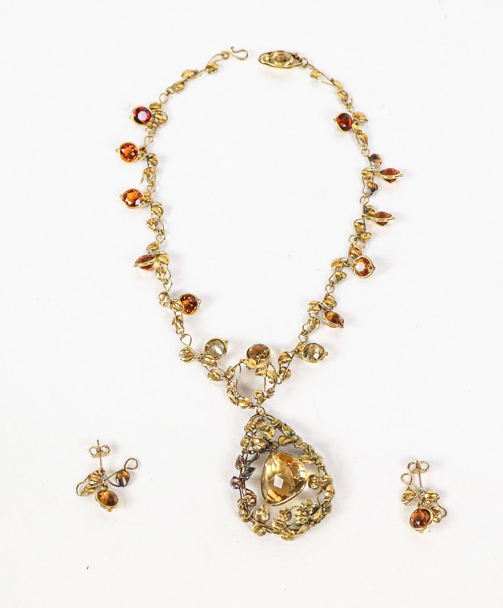 Arts & Craft Gold and Citrine Necklace & Earrings: Arts and Crafts grape and leaves gold and faceted citrine necklace and earrings, unmarked but tests for 14K gold. [Total 19.89 dwt., Necklace: 14" L]. Overall condition is good/fair, minor parts of so