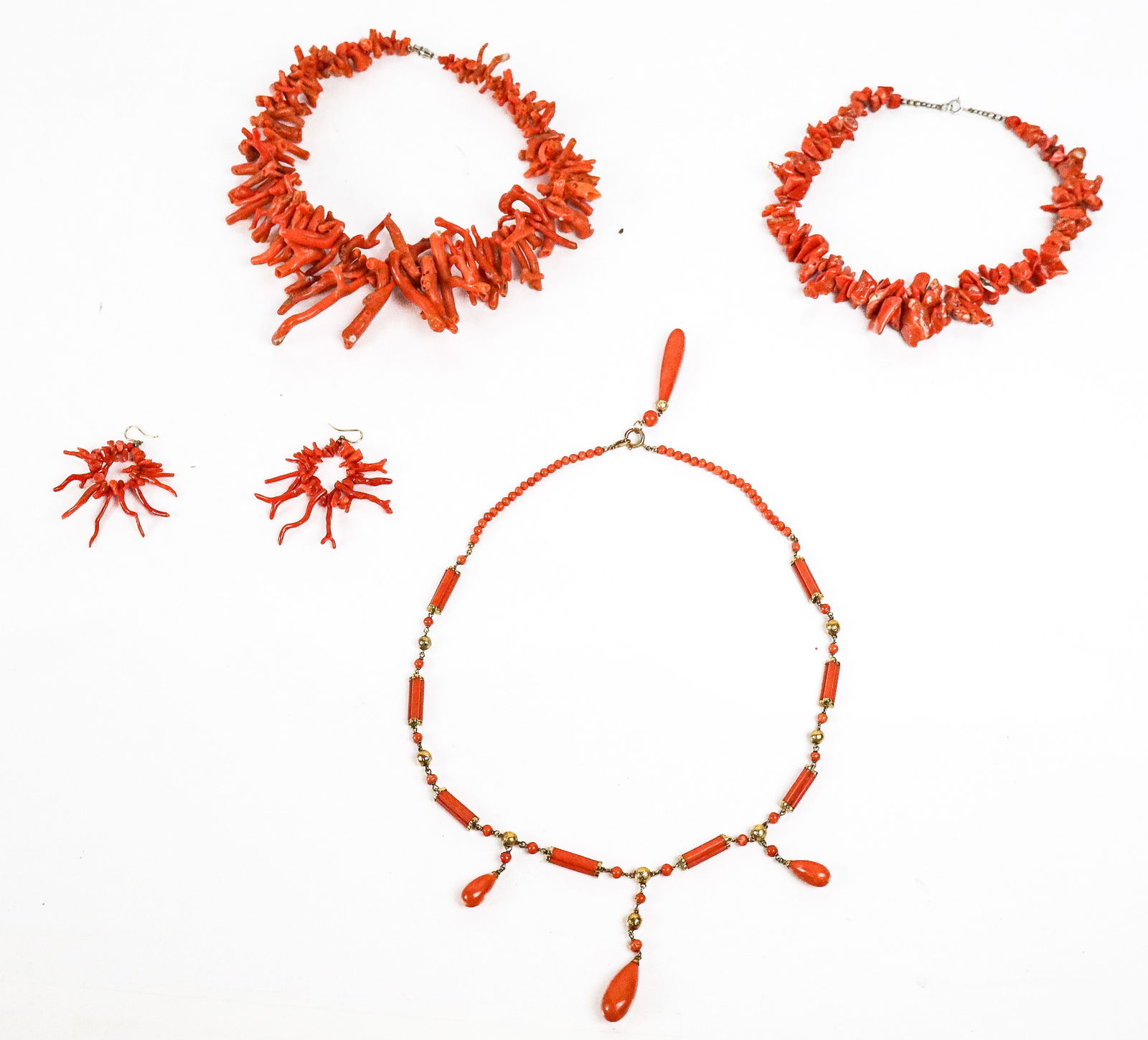 Collection of Coral Jewelry, 5: Collection of coral jewelry comprising 2 branch coral graduating necklaces [Largest 18" L x 4" W], pair of branch coral earrings, and a Victorian necklace with pendant drops. Overall condition varies,