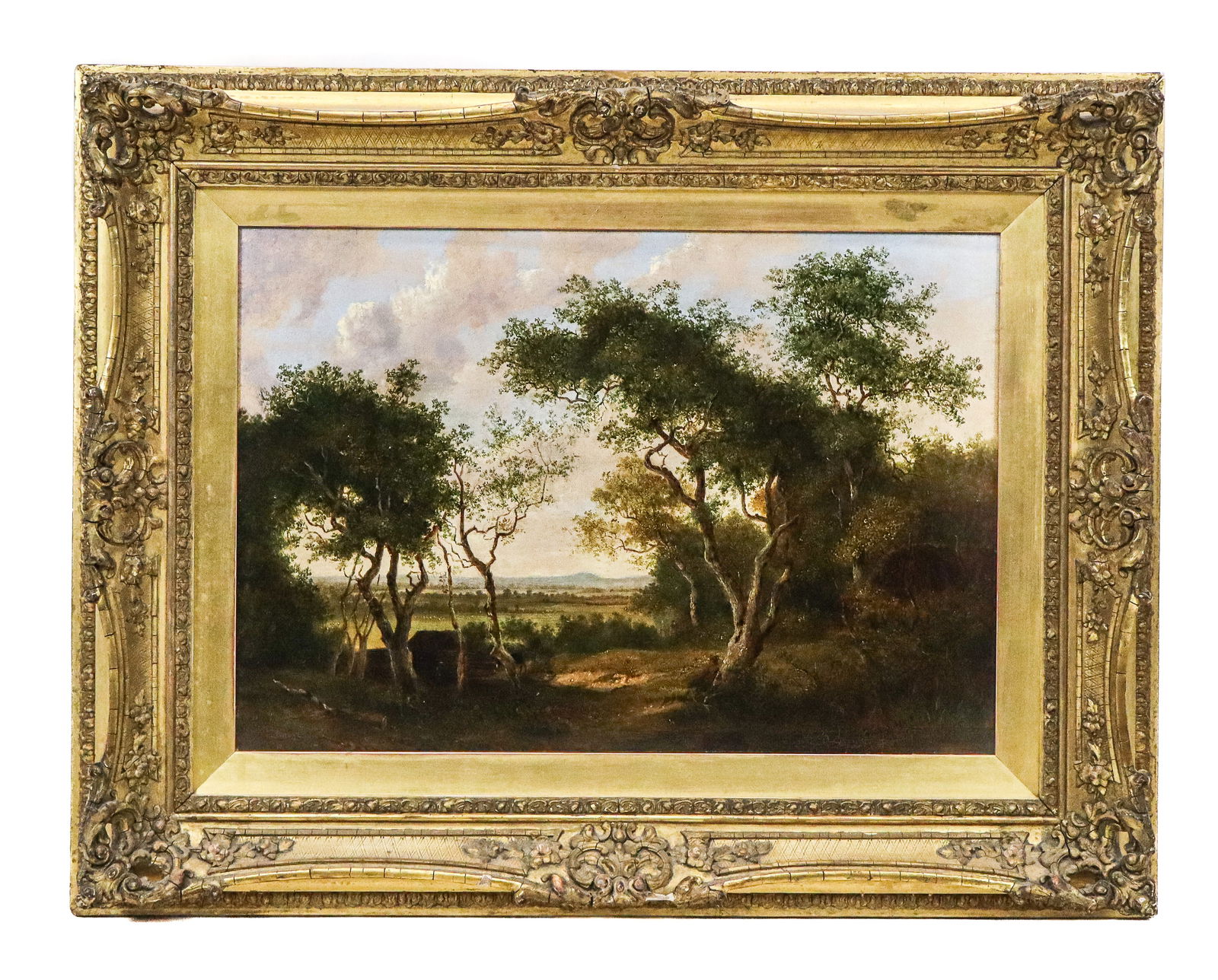 English School - Oil on Canvas: English School, oil on canvas of a landscape, view from a forest with a man sitting against a tree, with a lake and hills in the distance. Unsigned. 19th Century. Gilt carved and open corner frame. [A