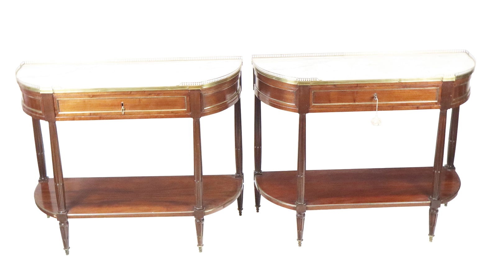 Pair French Directoire Two-Tier Dessertes: Pair French Directoire two-tier dessertes, Late 19th Century, with the top tier having a 3/4 brass pierced gallery on a marble top, stop fluted column supports over stop fluted and tapered legs, in ma