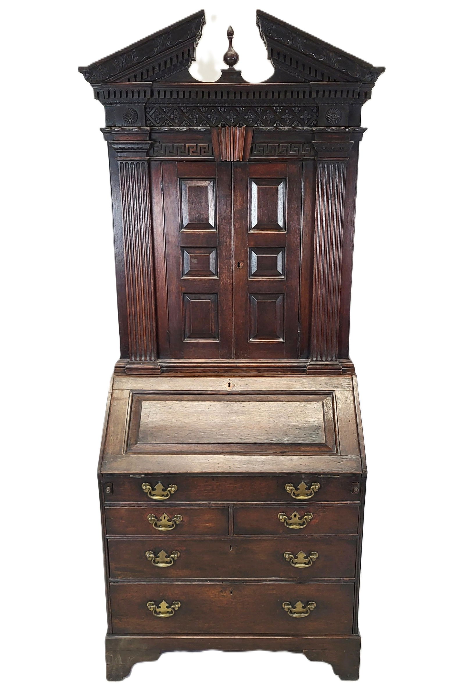Antique English Secretary Desk: Antique English secretary desk, with arched pediment top with finial, over a highly carved two door bookcase with linen fold mount and paneled doors, side columns, over a slant front secretary opening