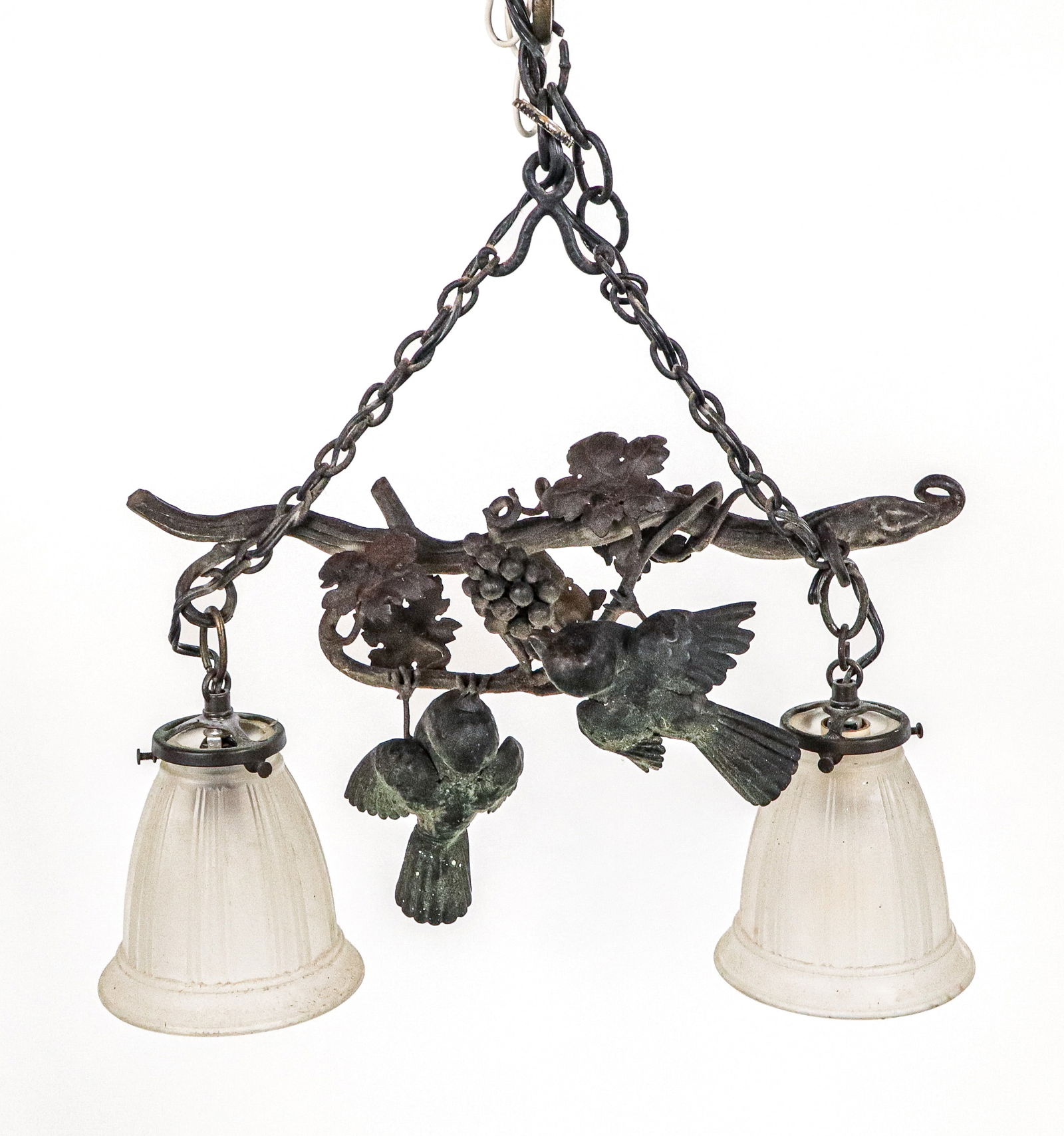 Iron and Frosted Glass Chandelier with Birds: Cast iron chandelier, 20th century, with two birds on a branch and grapes, over two frosted glass shades. [12" H x16" W]. Condition is good with some dust residue; wiring untested.