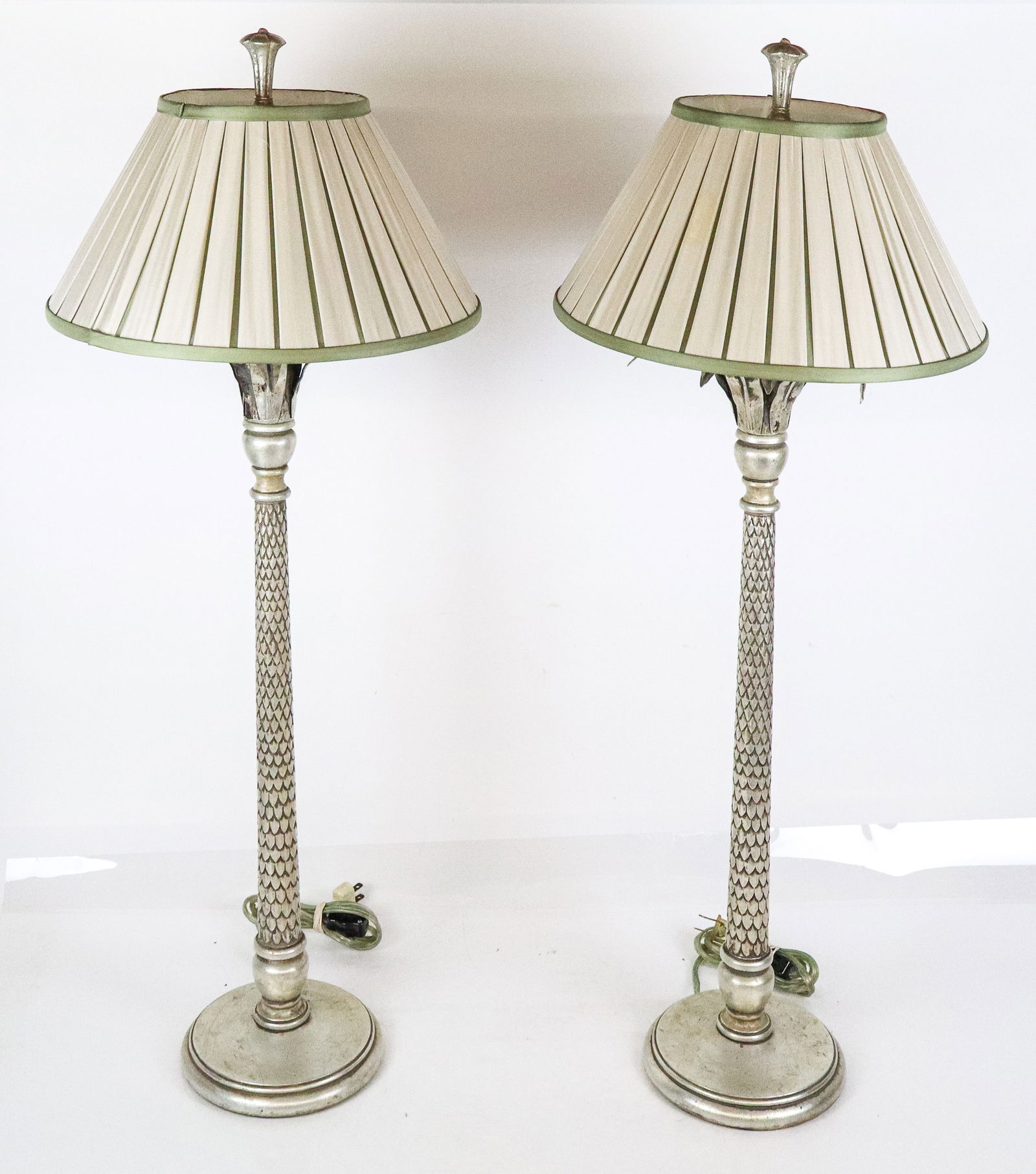 Pair of Hollywood Regency Silvered & Carved Lamps: Pair of Hollywood Regency palm tree form lamps, 20th century, with carved and silvered details, and green and off-white satin shades. [Less shades, to lower socket: 26" H x 8.5" Diameter]. Condition t
