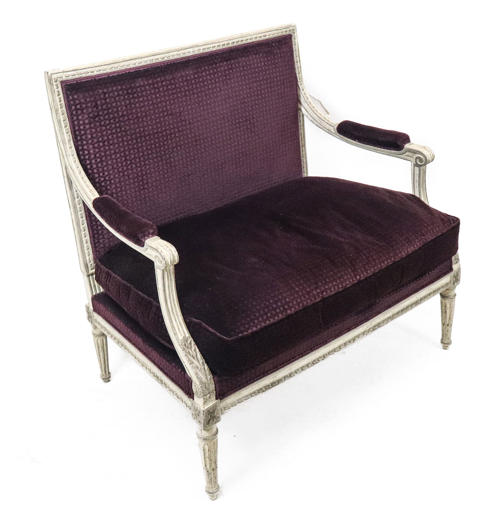 Louis XVI Carved and Painted Small Settee: Louis XVI carved and painted small settee, all around carved frame, in white painted wood and purple upholstery, open arms and down cushion, stop fluted legs. Late 19th century. [34" x 35" x 25"].