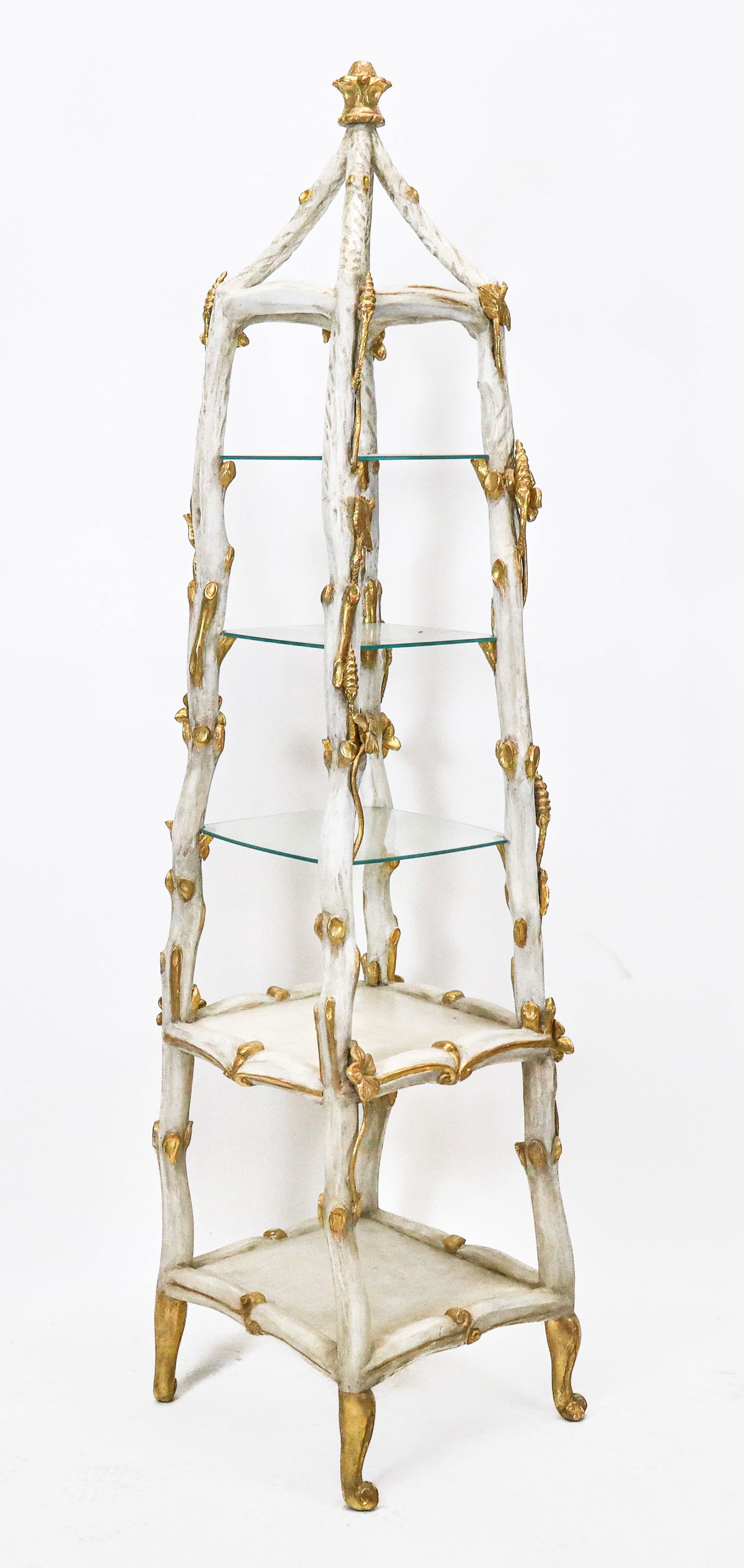 Hollywood Regency Obelisk Open Vitrine: Hollywood Regency obelisk shaped open vitrine, The carved wood 5 tier open vitrine with white painted and gilt carved flowers and twists inpost forms, having 3 glass and 2 wood tiers. gilt carved