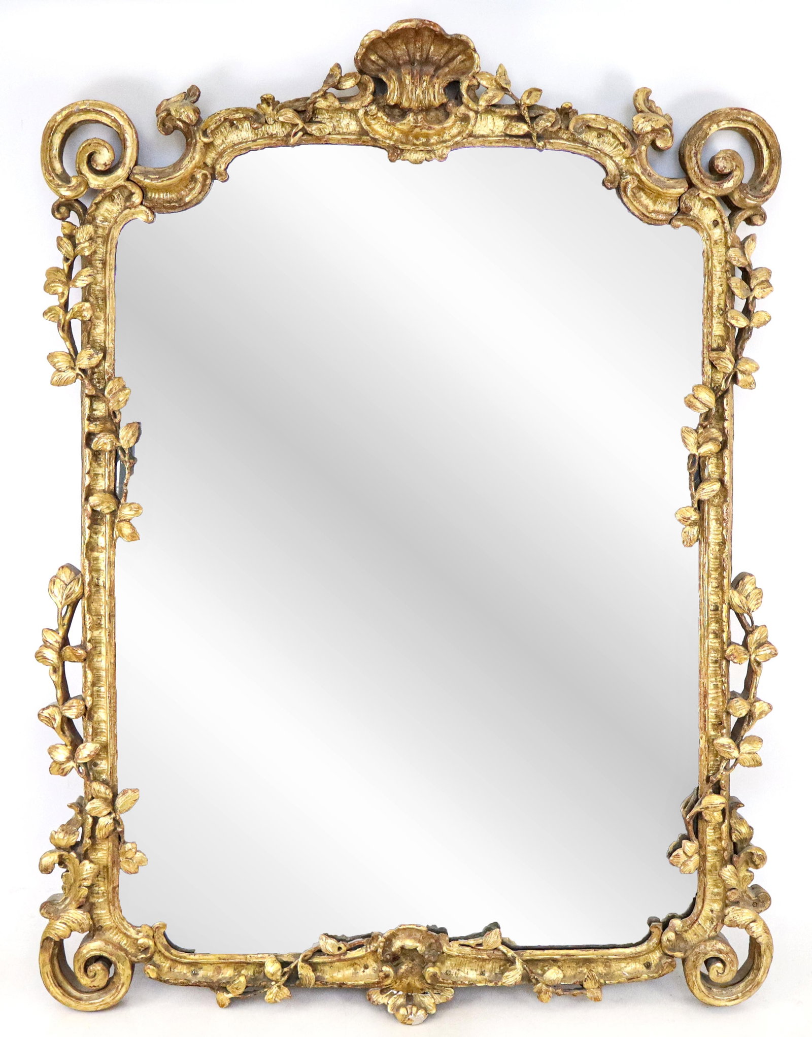 French Regence Gilt Rectangular Mirror: French Regence gilt carved rectangular mirror, with highly detailed and openwork gilt carved frame of a shell pediment, leafy vines about open scroll corners. 19th Century. [44" x 32"]. Good condition