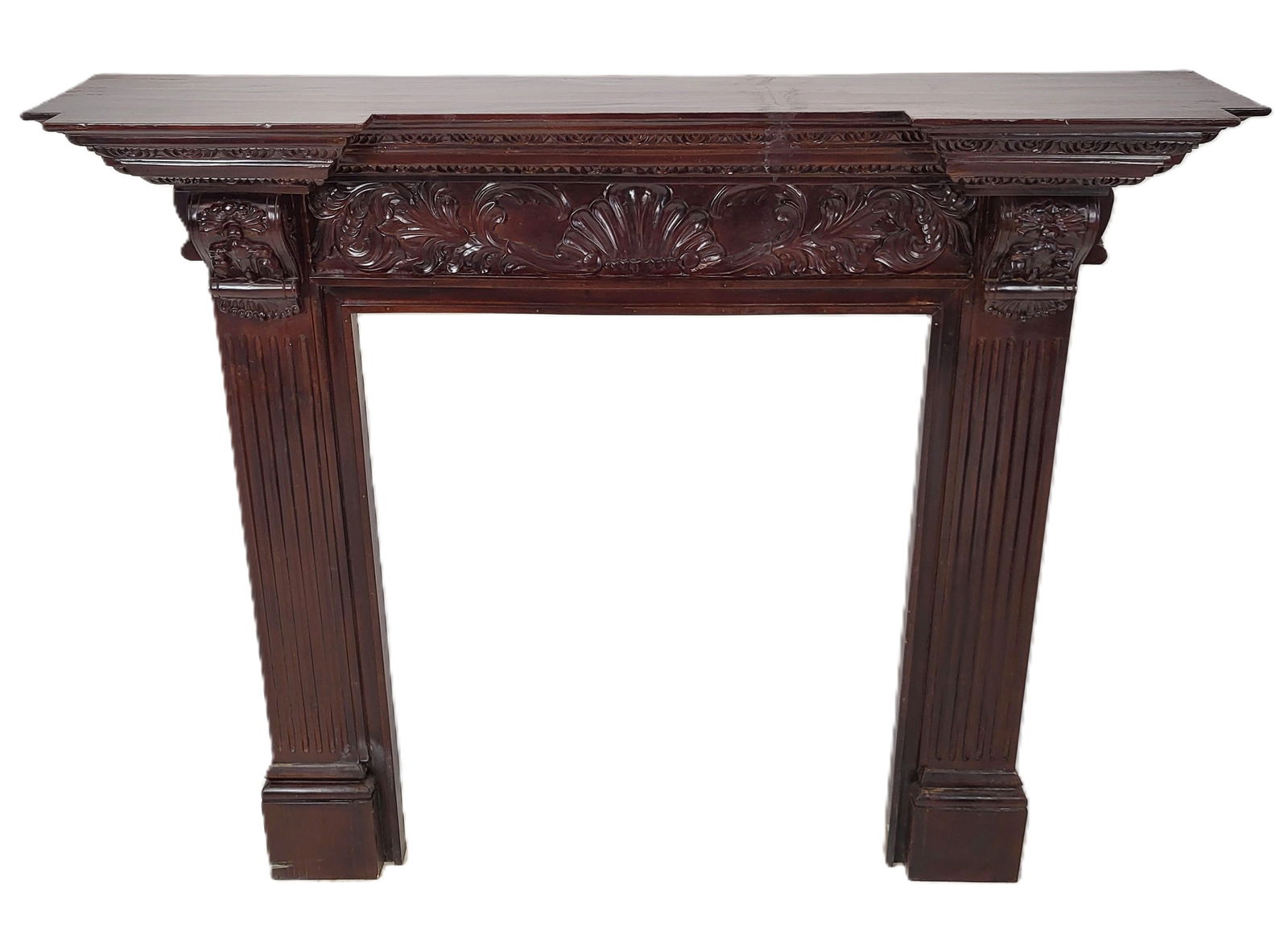 Neo Classical Fireplace Mantle: Neo Classical carved and stained wood fireplace mantle. Carved frieze above fluted half columns. [49" H x 56" W x 11" D, Opening 37" H x 30" W]. Good condition, some scratches.