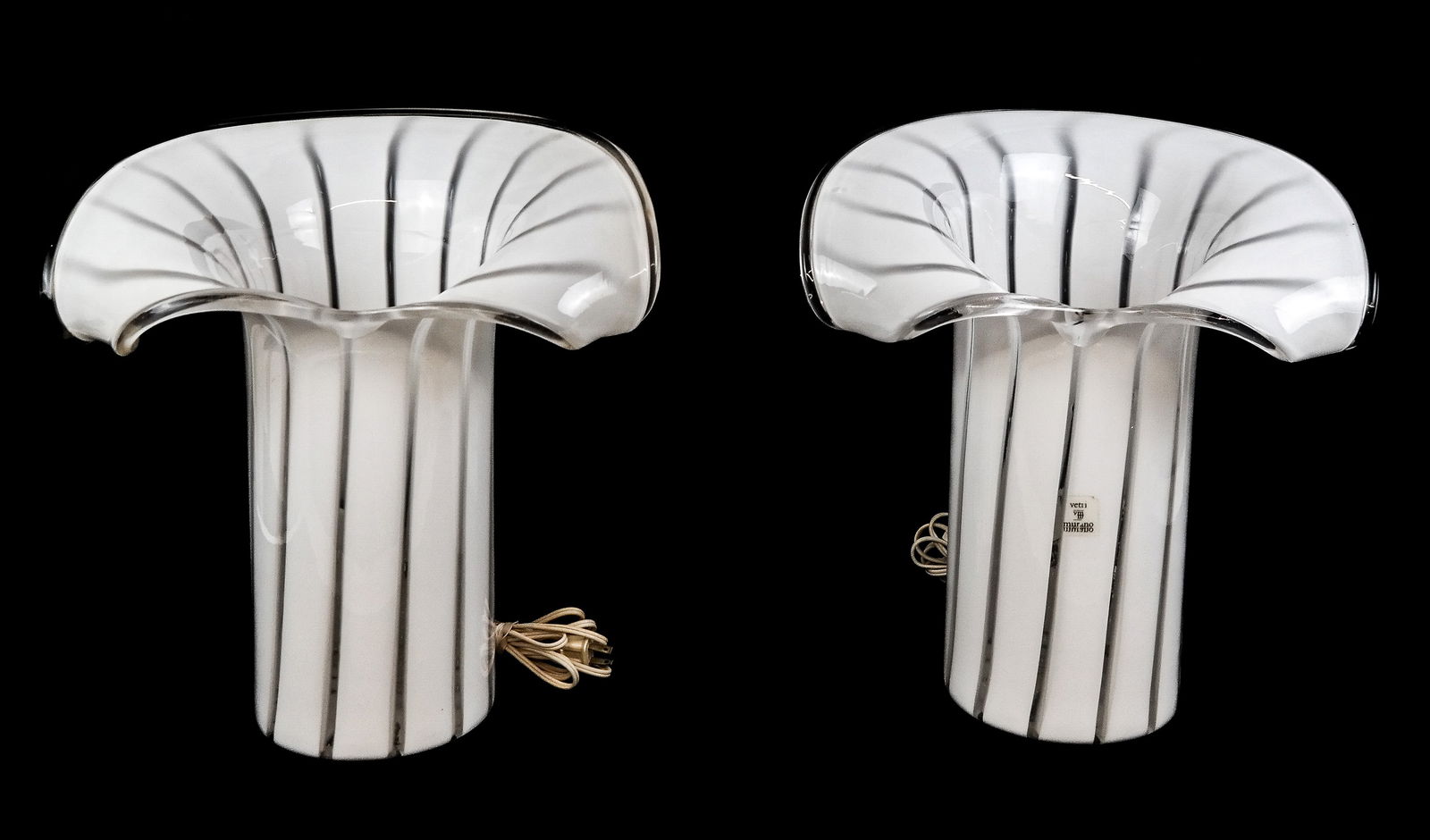 Pair of Murano Glass Calla Lilly Lamps: Pair of Murano glass calla lily lamps, Italy, 20th century, in white and colorless glass, one with affixed Vetri Murano authenticity label to one. [15" H x 14" W x 11" D]. Condition to each is good; w