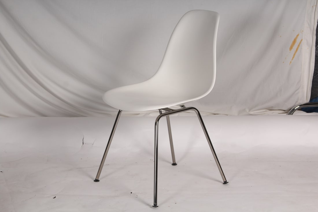 Eames for Herman Miller Plastic "Shell" Chairs, 2: Eames for Herman Miller white molded plastic "Shell" chairs, one with painted metal base, both impressed to seat base with Herman Miller icon and signed "Eames". [31" H x 18" W x 18" D, 16.5" Height