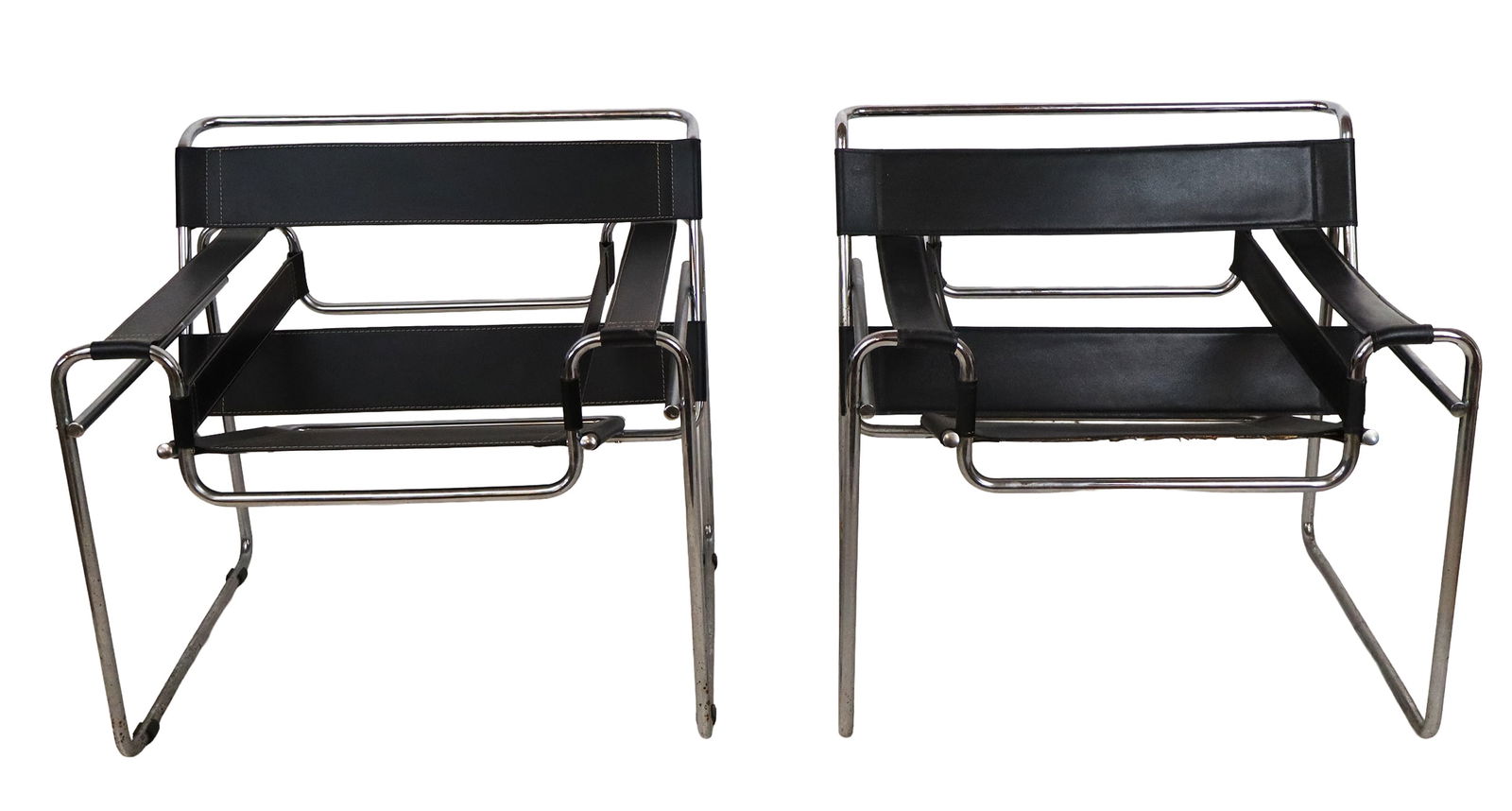 Pair of Wassily Style Armchairs: Pair of Wassily style armchairs, second half of the 20th century, after Marcel Breuer for Knoll Furniture, with chrome frames and leather seats and armrests, one with black stitching, the other with o