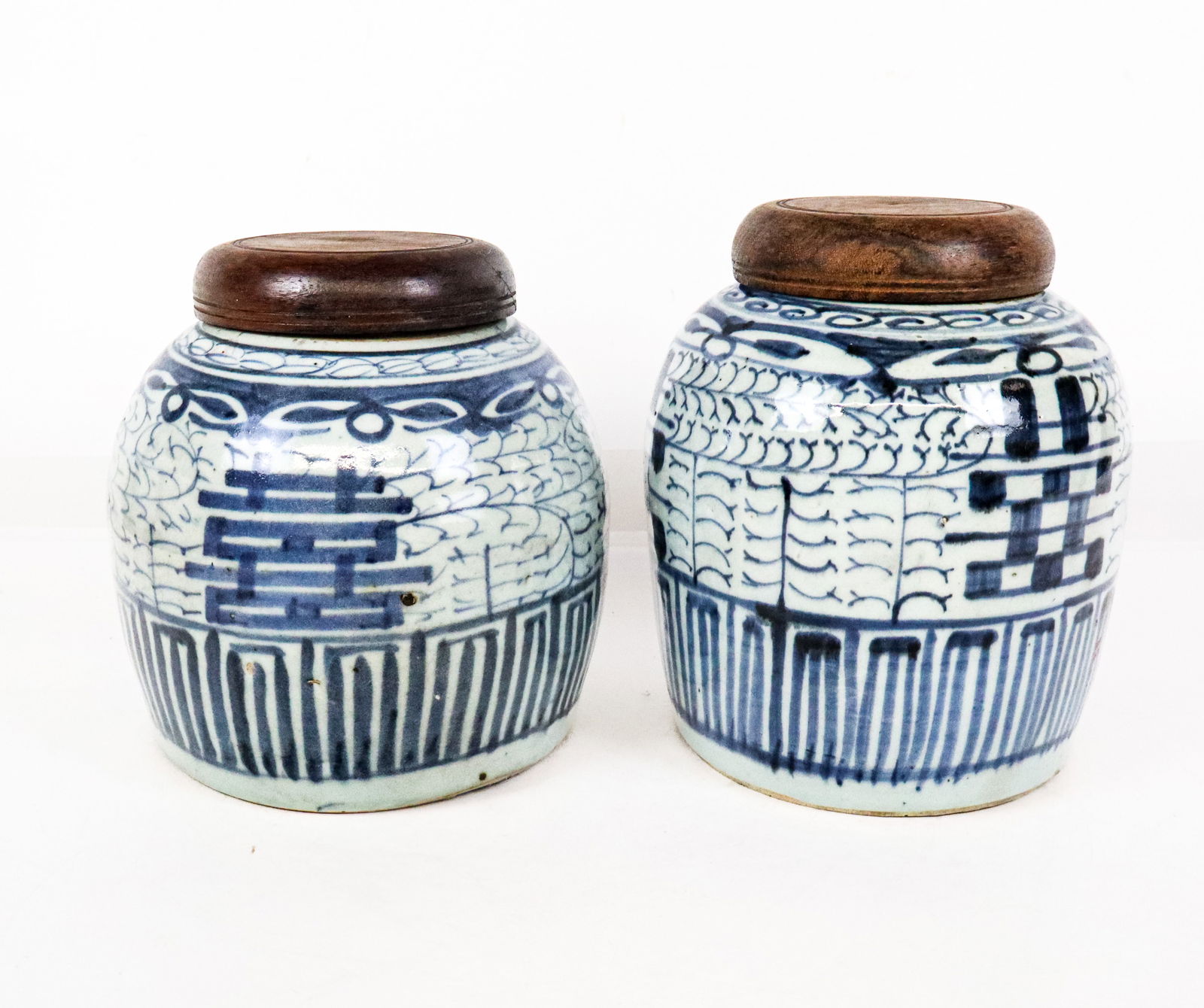 Near Pair Chinese Blue and White Ginger Jars: Near pair Chinese blue and white decorated ginger jars, Qing Dynasty, 19th century, with double happiness decoration, and wooden tops, unmarked, and accompanied by a certificate from the Hong Kong Art