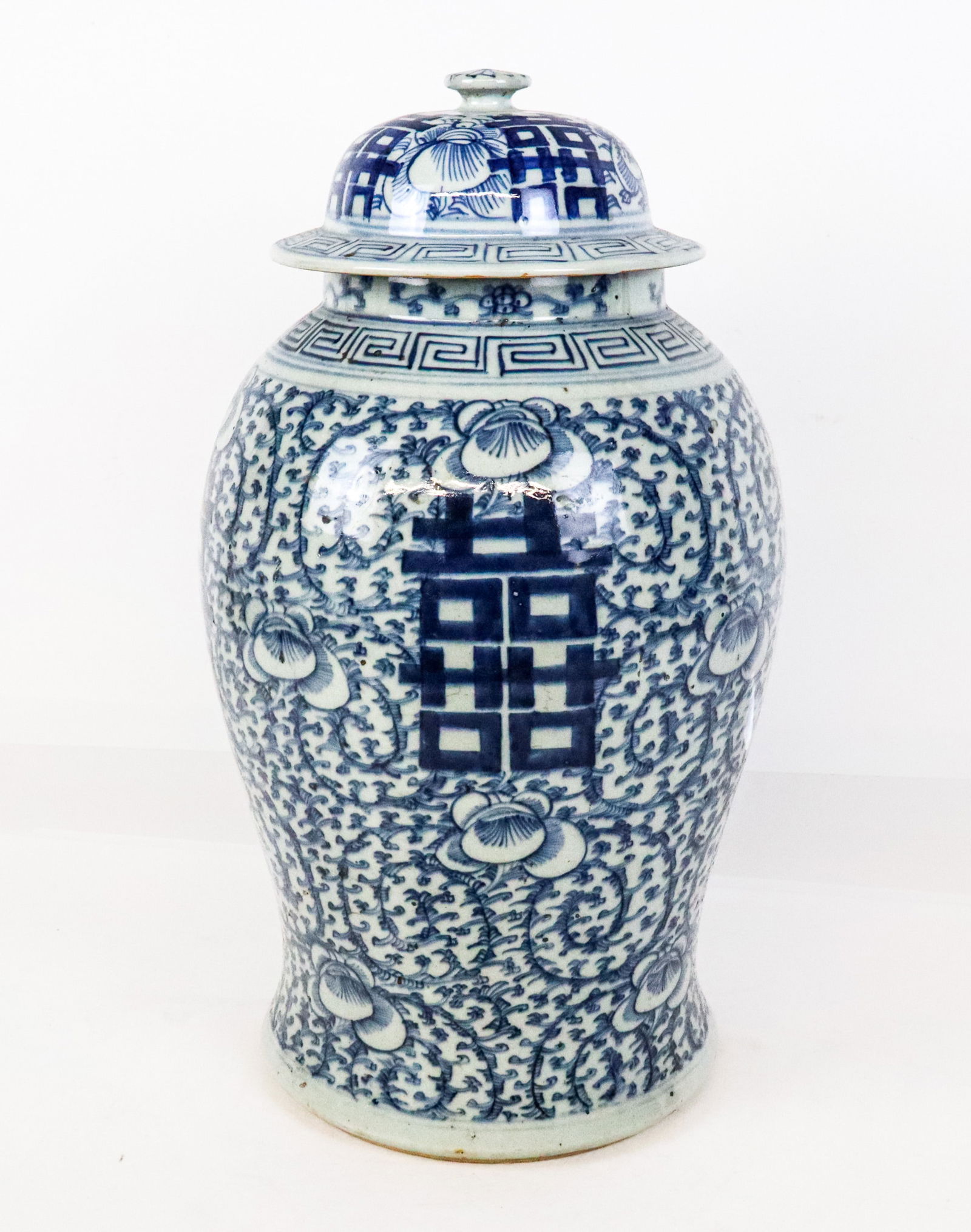 Chinese Blue and White Porcelain Ginger Jar: Chinese blue and white porcelain ginger jar, Qing Dynasty, 19th century, with floral and double happiness decoration, and apocryphal Ming Dynasty marks to base. [18.5" H x 10" Diameter]. Condition is