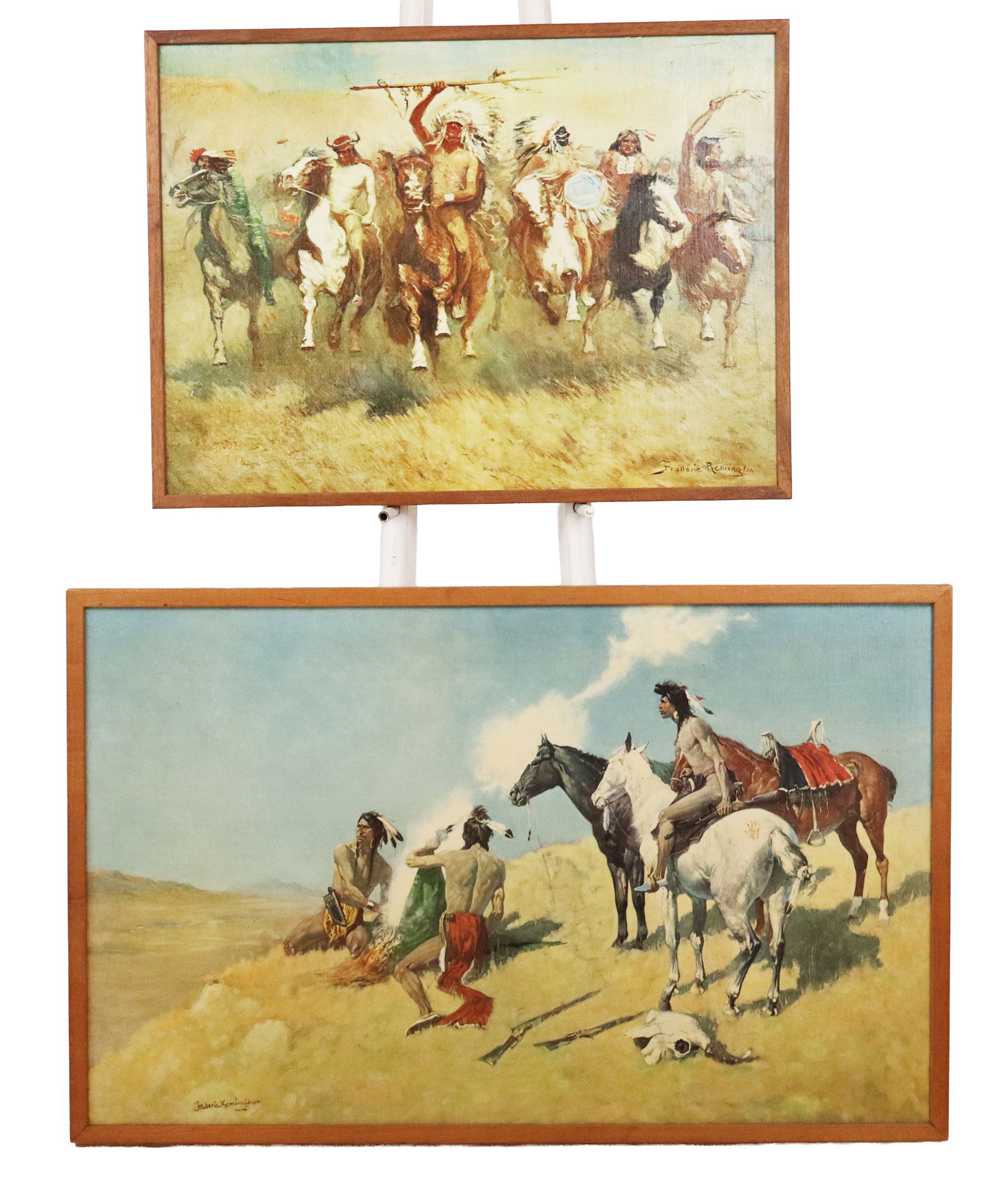 Two Prints on Canvas after Frederic Remington: Two prints on canvas after Frederic Remington comprising a print of "Victory Dance" and a print of "The Smoke Signal", both in frames. [Larger: 25.25" H x 40.25" W]. Condition to each is good.