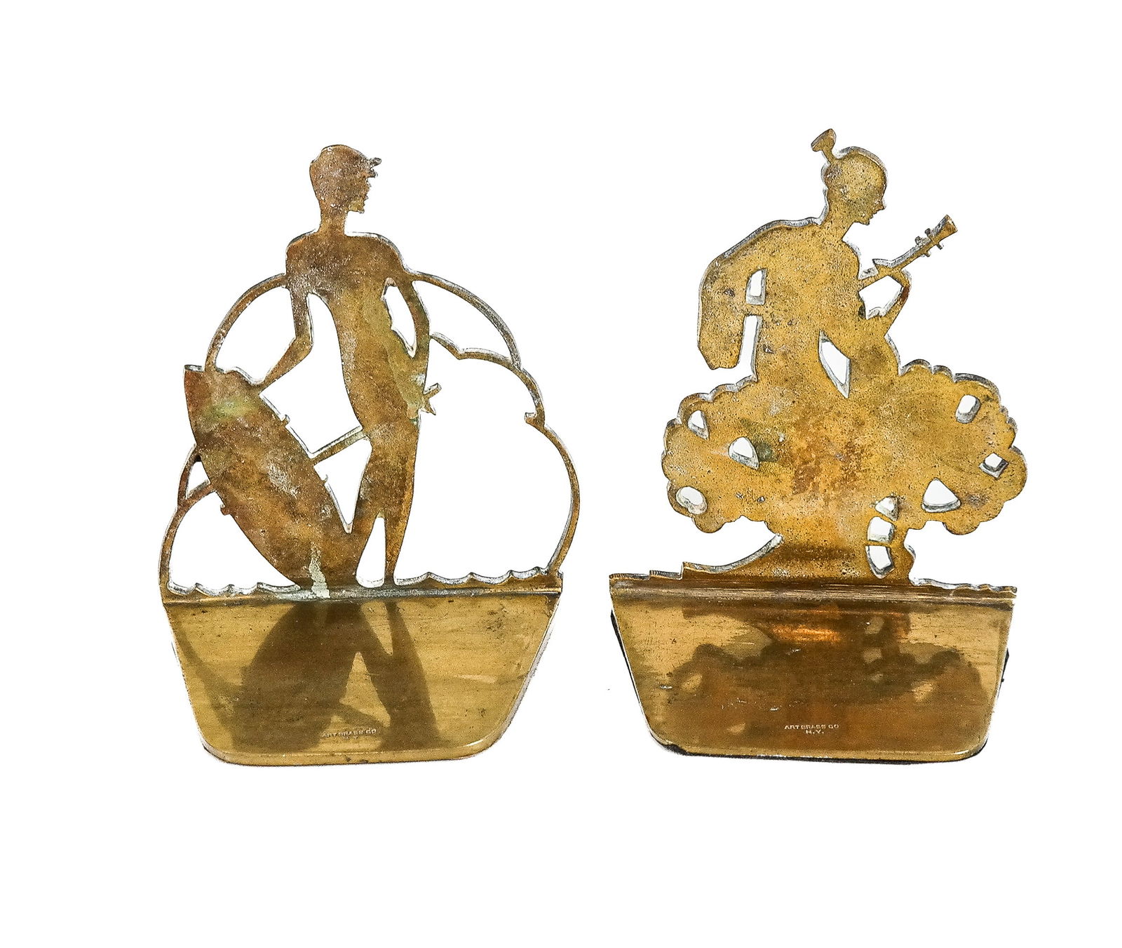 Brass Co Pair of Brass Silhouette Figural Bookends: Brass Co. pair of brass silhouette figural bookends depicting a musician and a golfer, signed "Brass Co. NY". [4.75" H x 4" W x 2.5" D]. Overall condition is good/fair, with scratches and