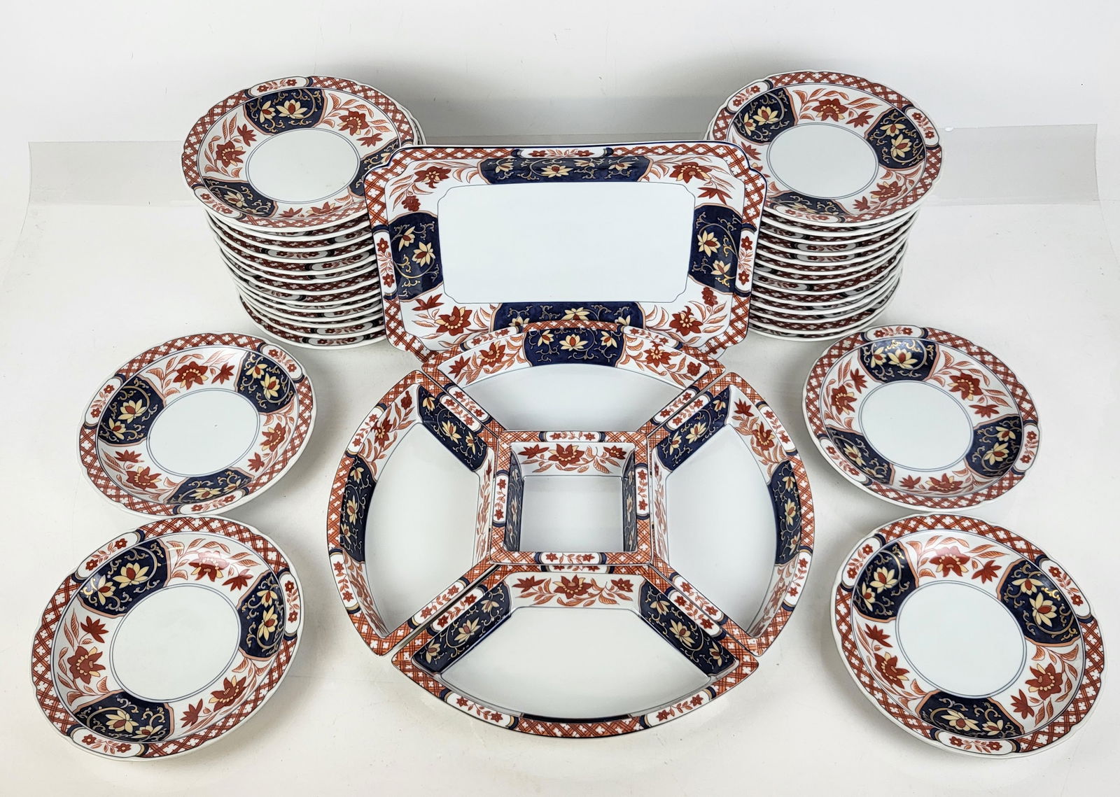 Takahashi Imari Decorated Dessert Set, 36: Takahashi modern Imari decorated dessert service comprising 30 dessert plates [7.5" Diameter], a rectangular tray [9" W x 12.25" L]; 4 wedge-shaped dishes [1.25" H x 10.25" W x 5.25" D], and a square