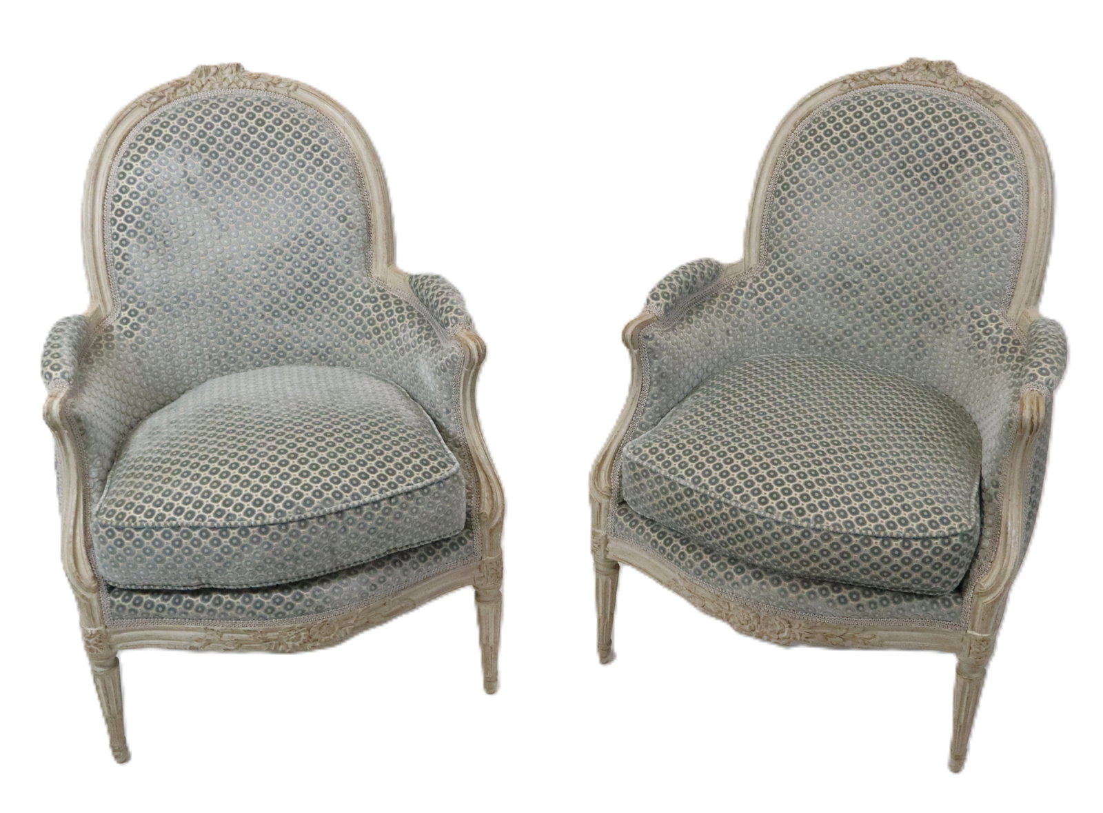 Pair French Painted Bergeres: Pair French painted and carved bergeres with blue tint crushed velvet pattern upholstery, and pad arms, and down seat cushions, stop fluted legs, carved and painted off white frame. [37" H x 26" W x 3