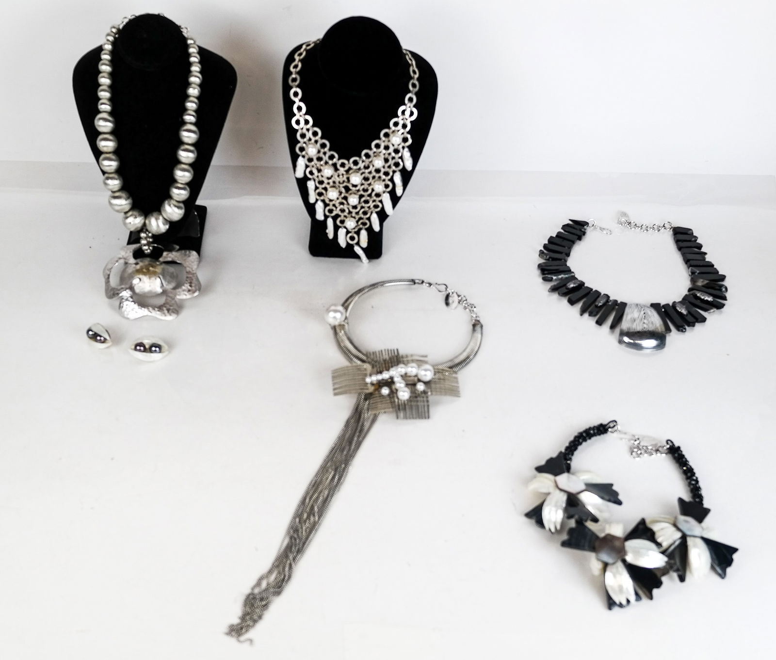 Vilaiwan Collection of Costume Jewelry (7): Vilaiwan collection of costume jewelry comprising 5 monumental necklaces of silvered-metal, pearl, faux pearl, plastic and mother-of-pearl jewelry and pair of ear clips, signed. Overall condition is g